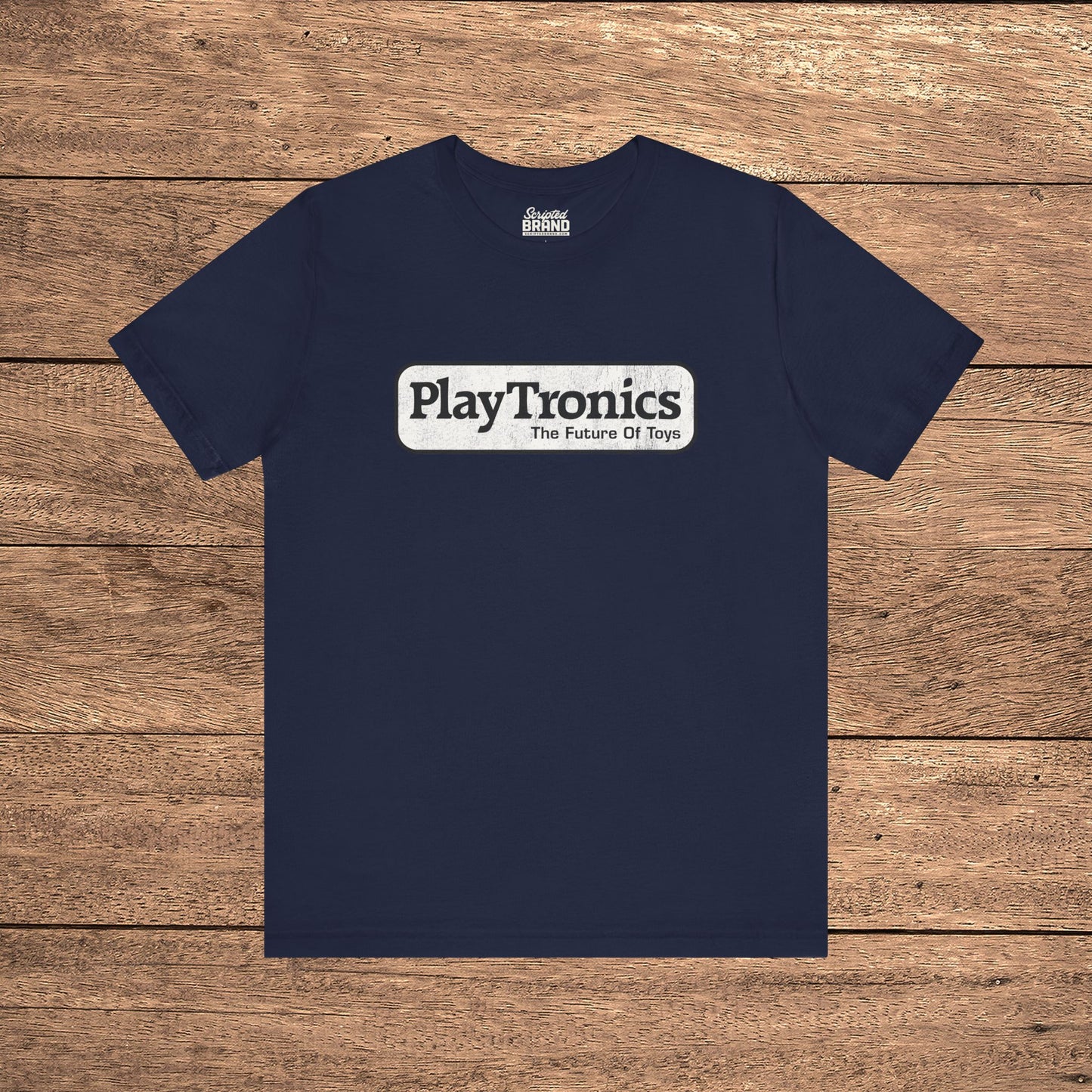 Navy blue PlayTronics Sneakers movie logo t-shirt on Bella+Canvas 3001, vintage distressed print, shown on wood floor.