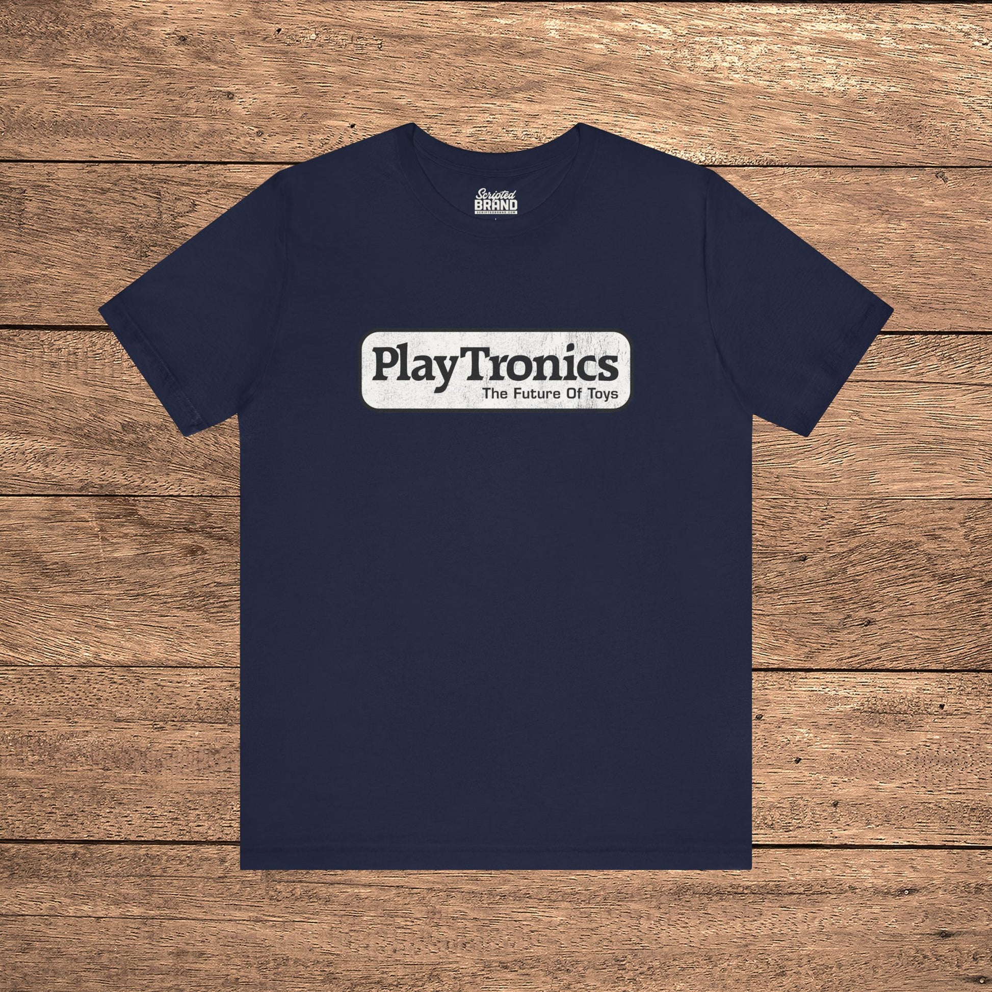 Navy blue PlayTronics Sneakers movie logo t-shirt on Bella+Canvas 3001, vintage distressed print, shown on wood floor.