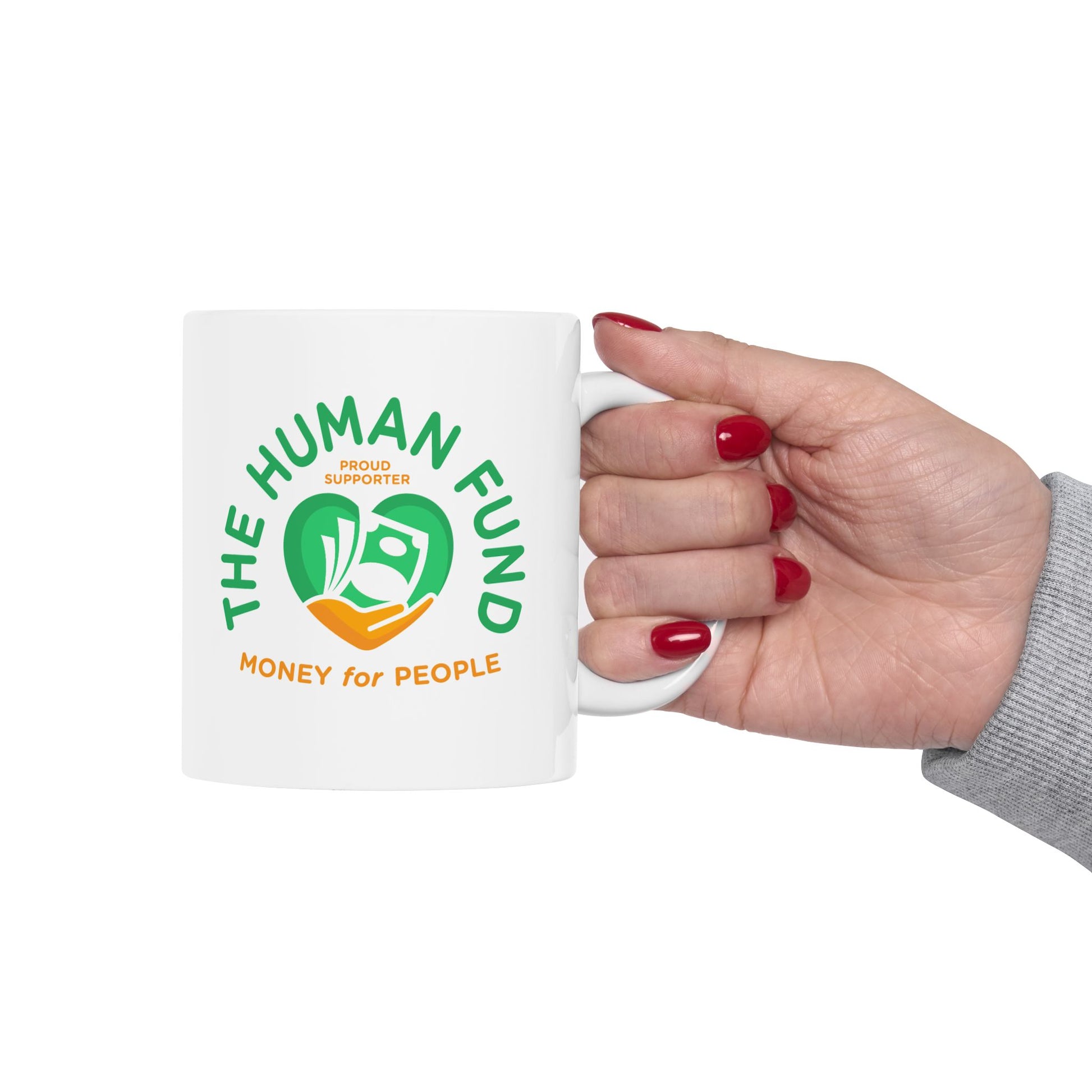 White mug with 'The Human Fund' logo held by a hand on a white background
