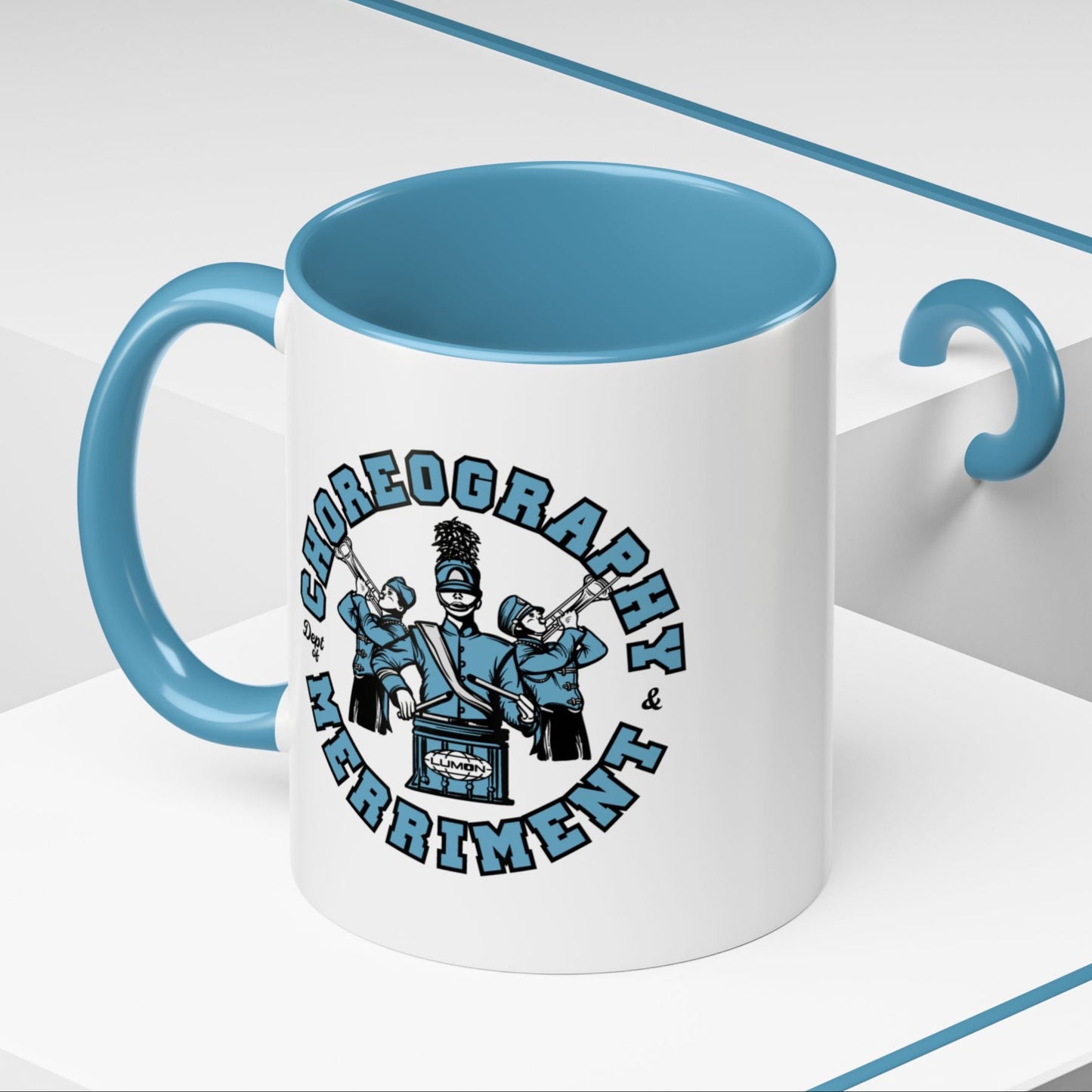 Angled view of 11 oz White ceramic accent mug with blue handle featuring Severance Dept. of Choreography & Merriment graphic.
