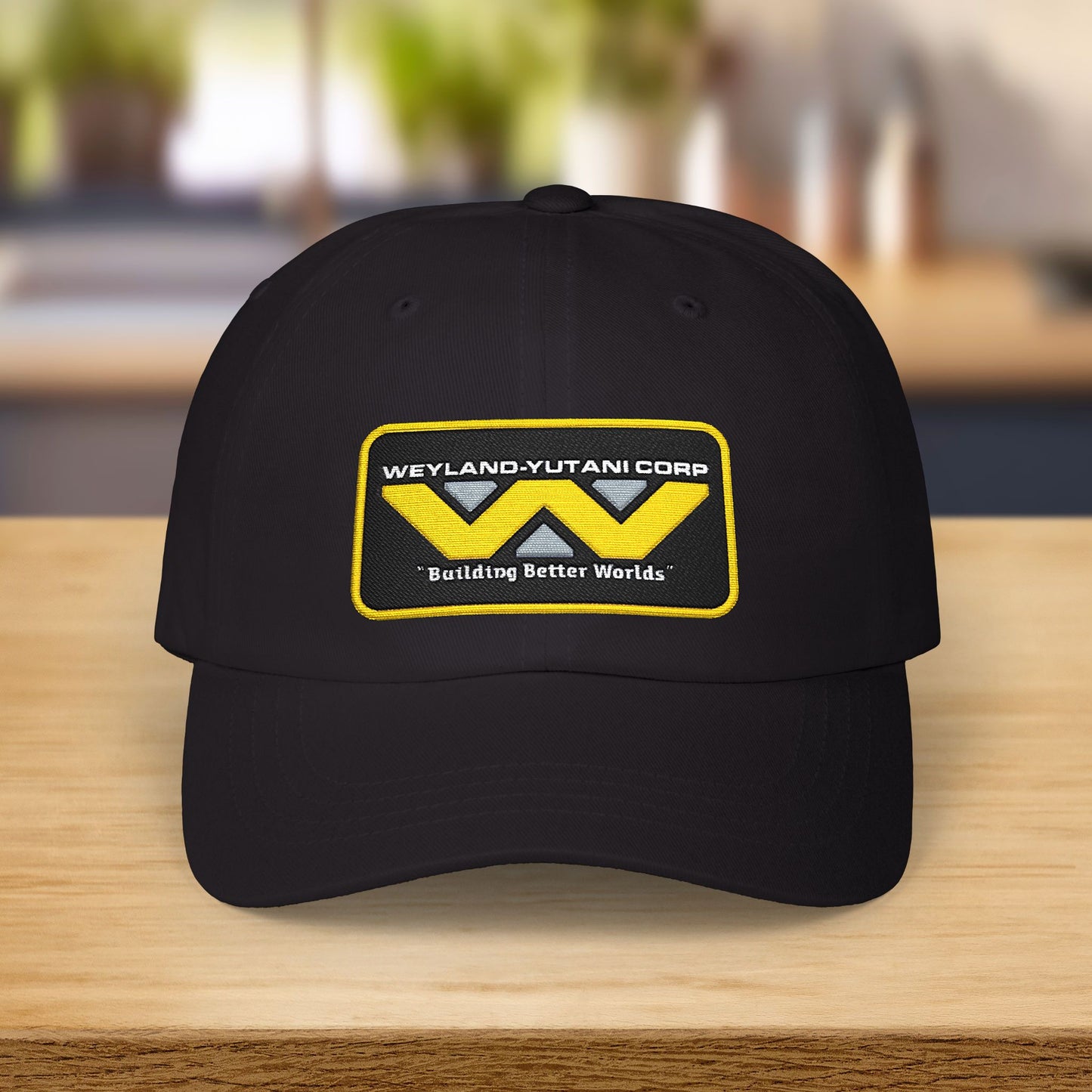 Black Yupoong dad cap with embroidered Weyland-Yutani Corp patch logo from the Alien franchise in yellow and silver