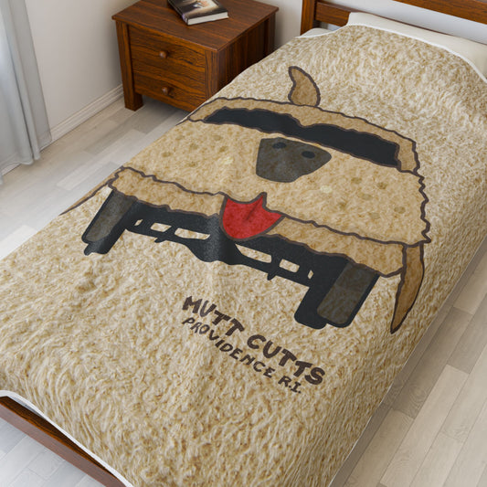 60x80 Velveteen plush blanket with large Mutt Cutts dog van graphic inspired by Dumb and Dumber, shown on a bed.