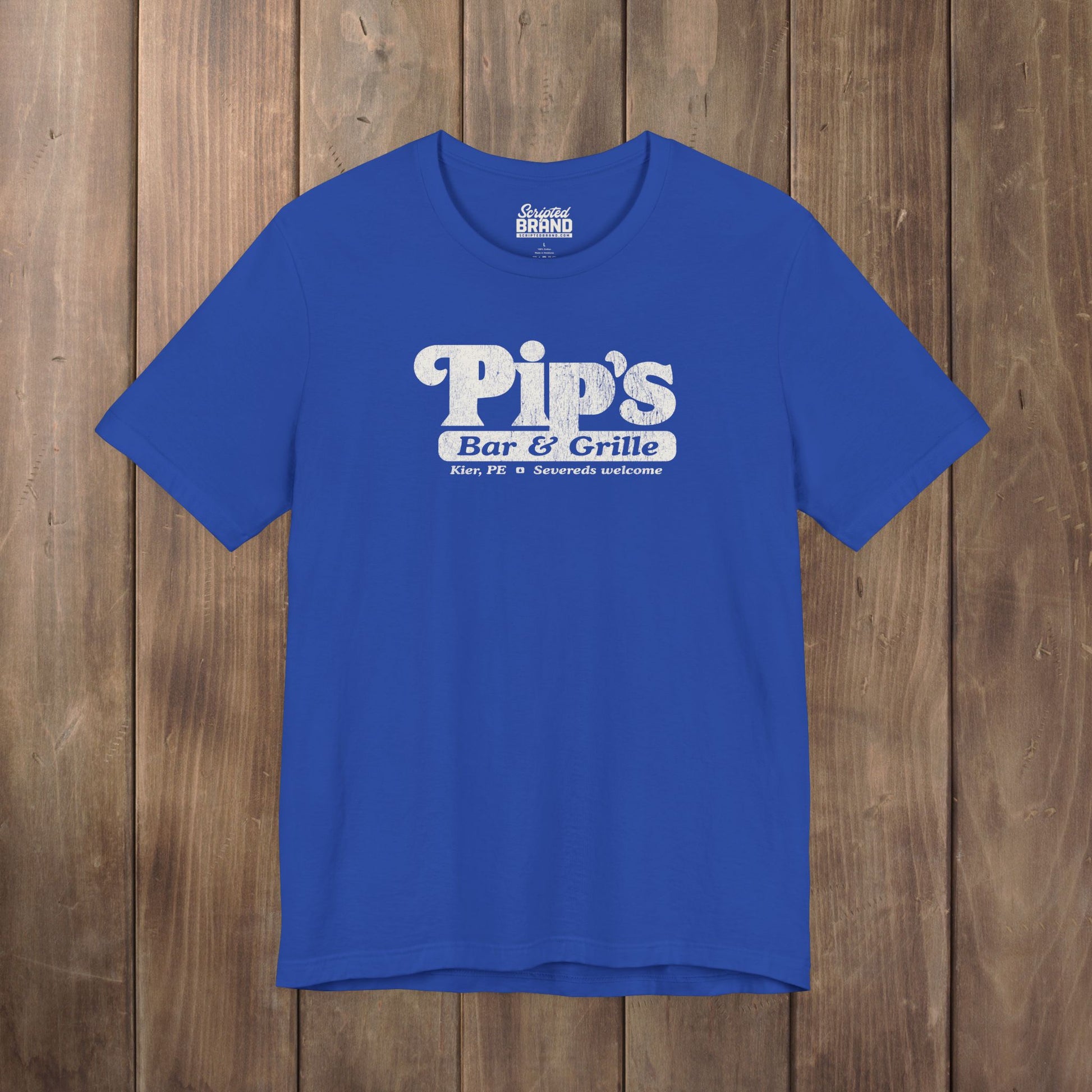 Royal blue Bella+Canvas t-shirt with the Pips Bar and Grill logo from the TV show Severance in a vintage distressed style.