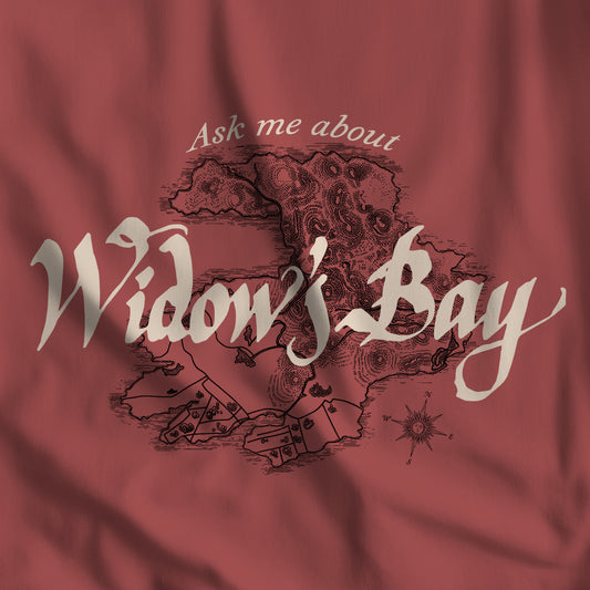 Closeup of Crimson Comfort Colors tee with a vintage island map and antique "Ask Me About Widow's Bay" type from the Apple TV show