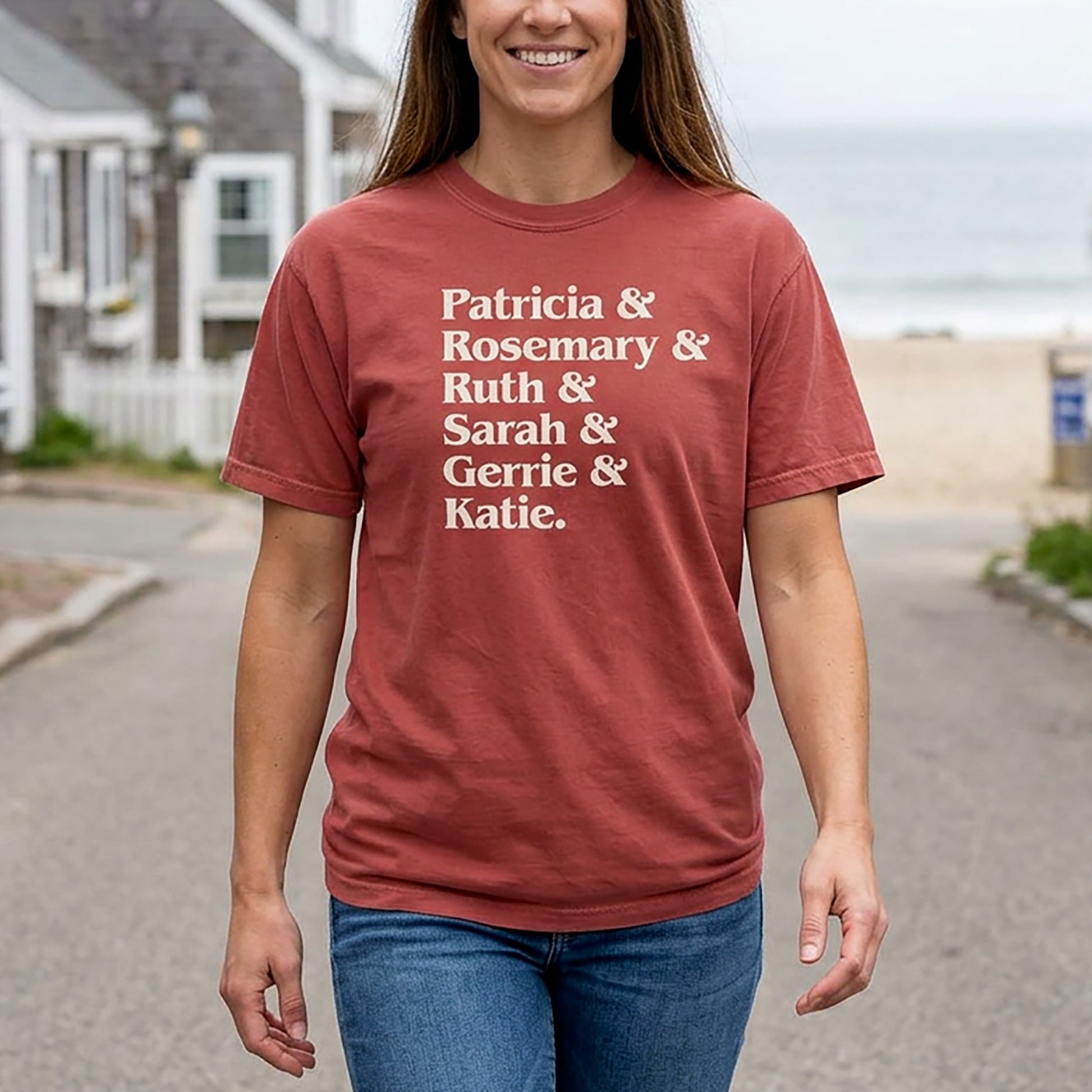 Woman wearing Crimson Comfort Colors tee listing the women of Widow's Bay: Patricia, Rosemary, Ruth, Sarah, Gerrie, and Katie