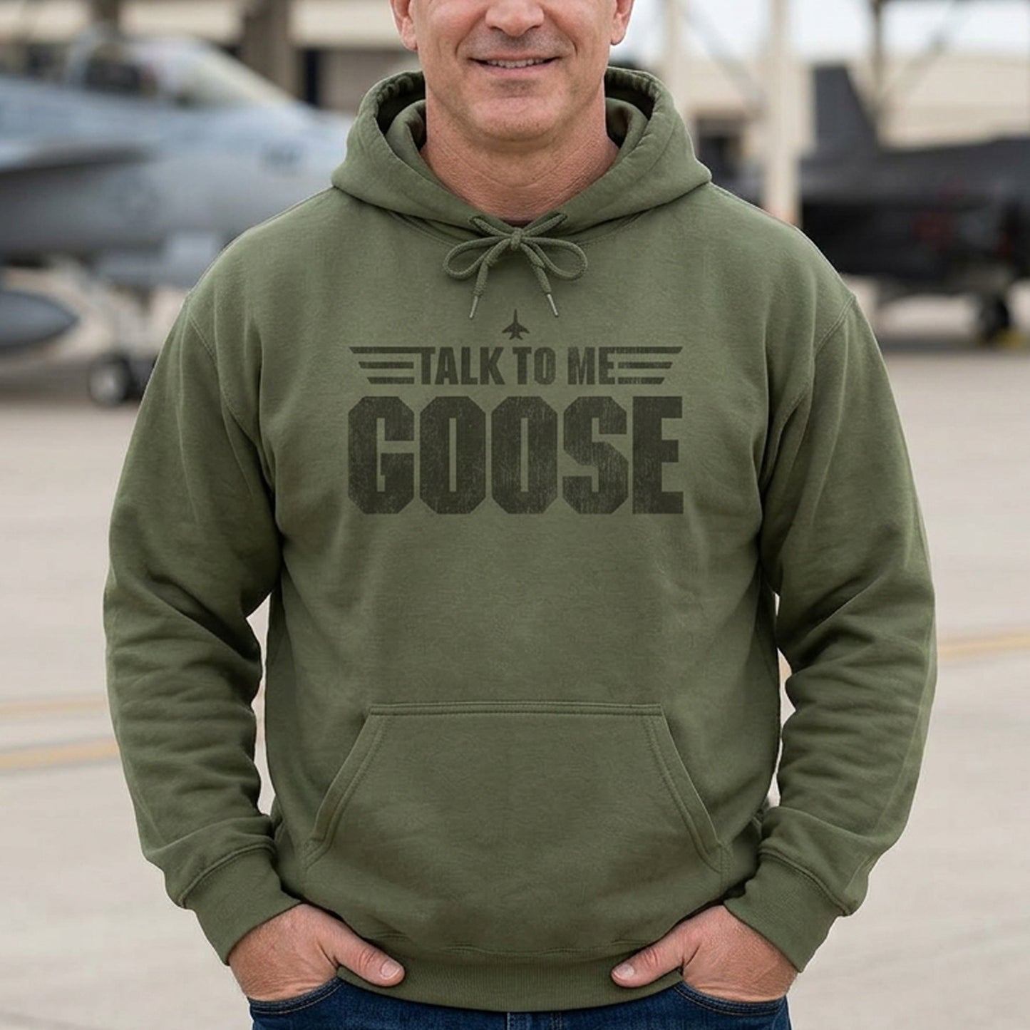 Man wearing military green Talk to Me Goose vintage distressed graphic hoodie inspired by Top Gun, heavy blend cotton sweatshirt
