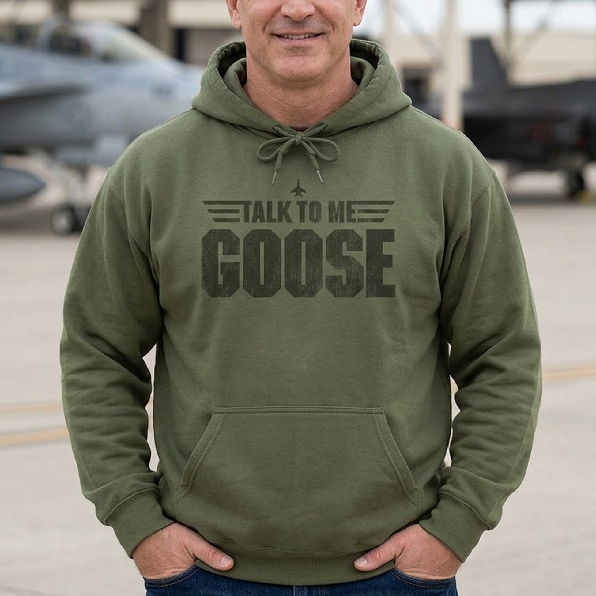 Man wearing military green Talk to Me Goose vintage distressed graphic hoodie inspired by Top Gun, heavy blend cotton sweatshirt