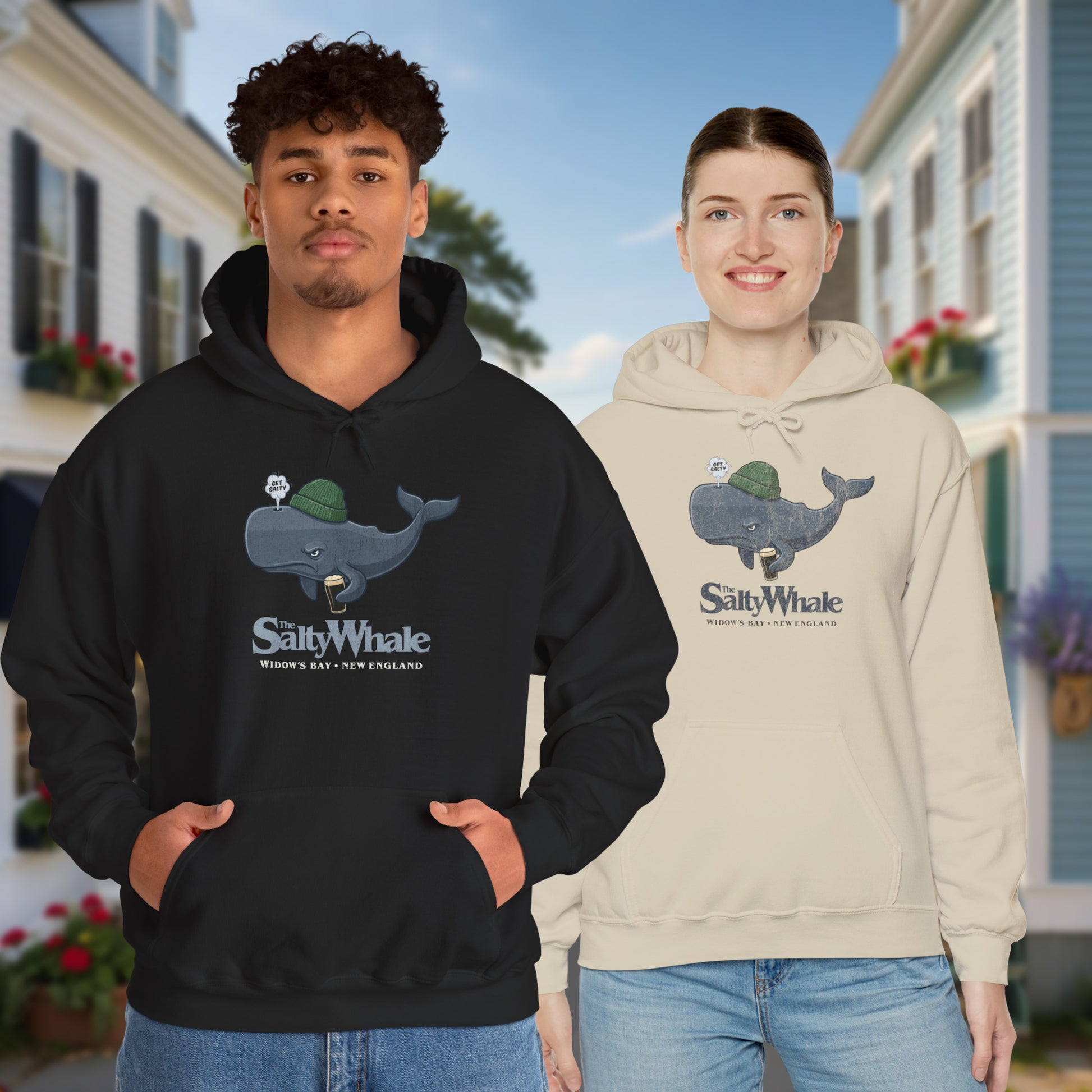 Two people wearing 'The Salty Whale' cartoon mascot hoodies inspired by Widow's Bay Apple TV series, heavy blend pullover sweatshirt