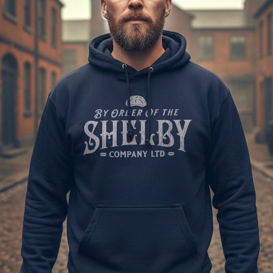 Man wearing navy blue Unisex Gildan 18500 Heavy Blend Hoodie Sweatshirt with a vintage Shelby Company Limited logo graphic from Peaky Blinders.