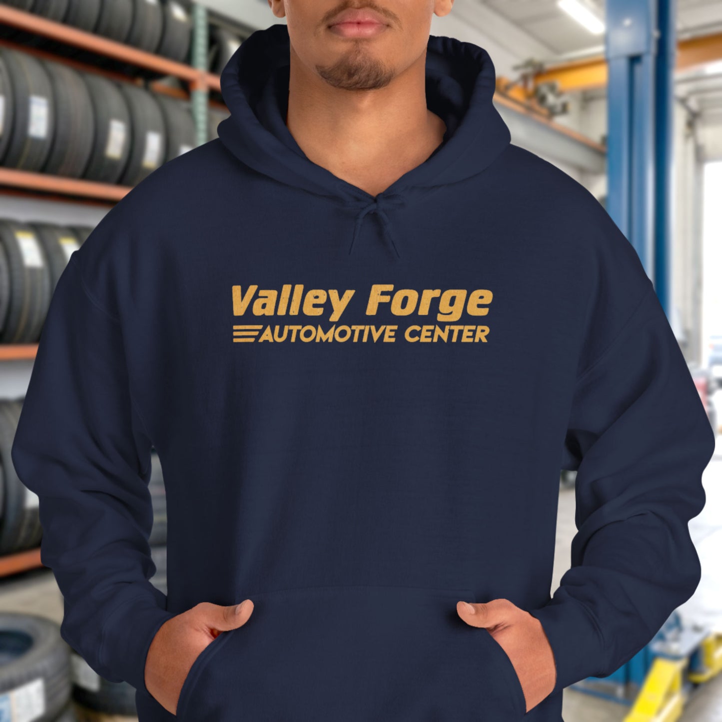 Person wearing Navy blue Valley Forge Automotive Center hoodie with distressed logo, Tires TV show inspired sweatshirt
