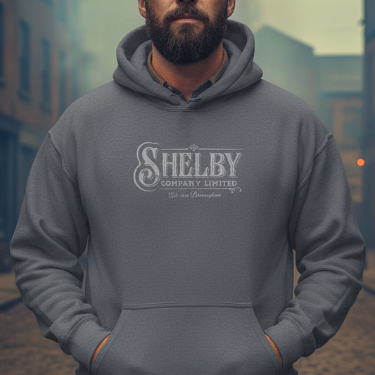 Man wearing a Dark Heather Gray Unisex Hoodie Sweatshirt with the vintage Shelby Company Limited logo from Peaky Blinders.