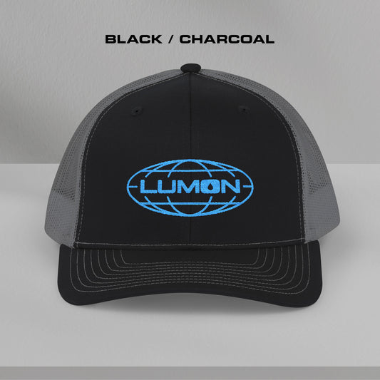 Front view of a black and charcoal Richardson 112 trucker cap with embroidered blue Lumon Industries logo inspired by Severance.