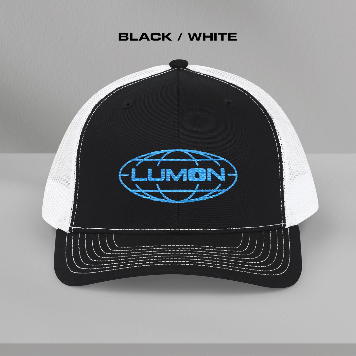 Front view of a black and white Richardson 112 trucker cap with embroidered blue Lumon Industries logo inspired by Severance.