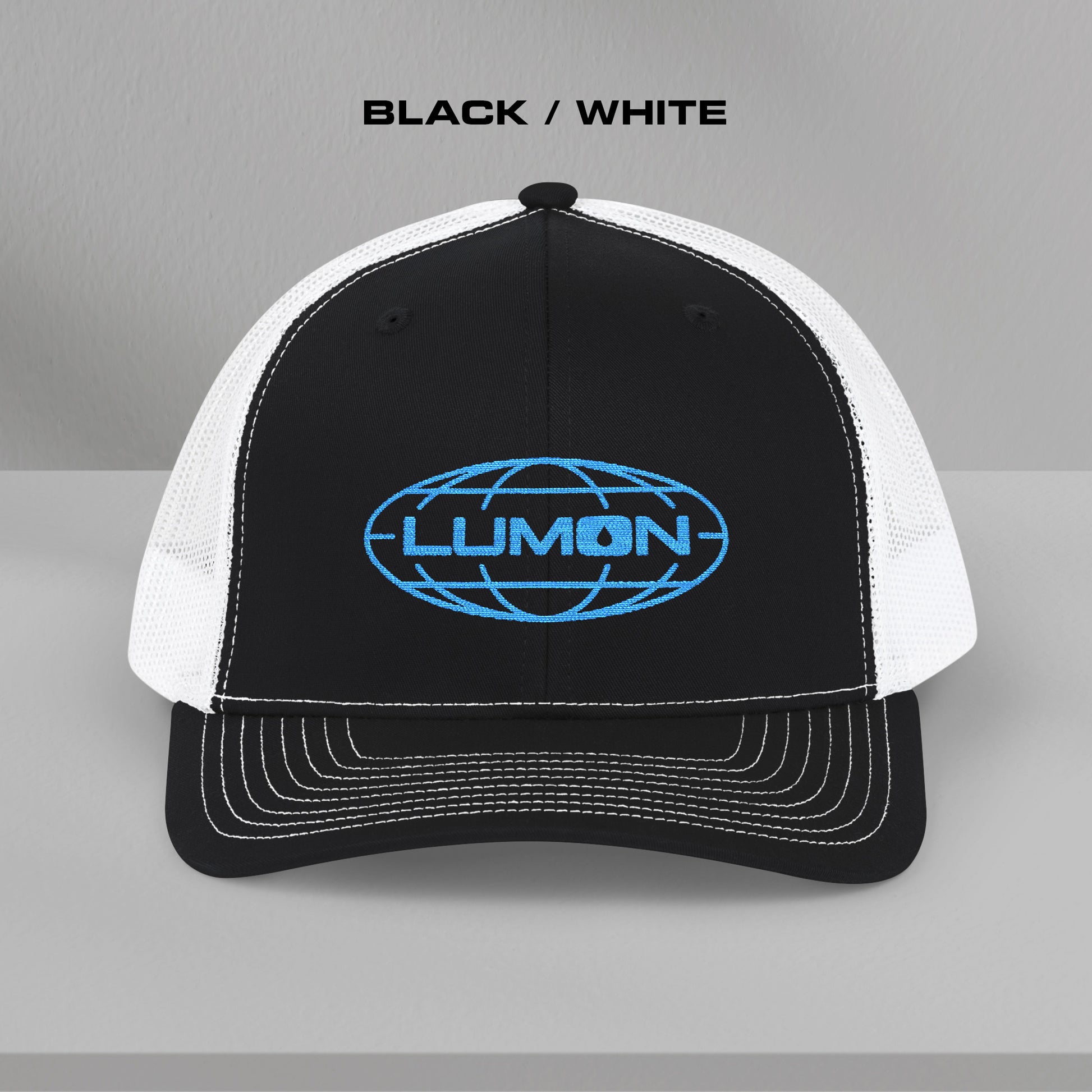 Front view of a black and white Richardson 112 trucker cap with embroidered blue Lumon Industries logo inspired by Severance.