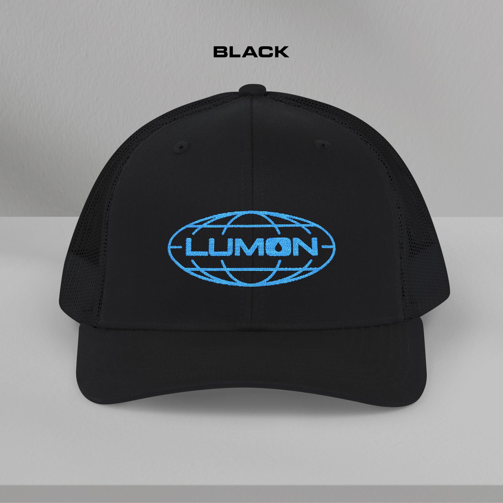 Front view of a black Richardson 112 trucker cap with embroidered blue Lumon Industries logo inspired by Severance.