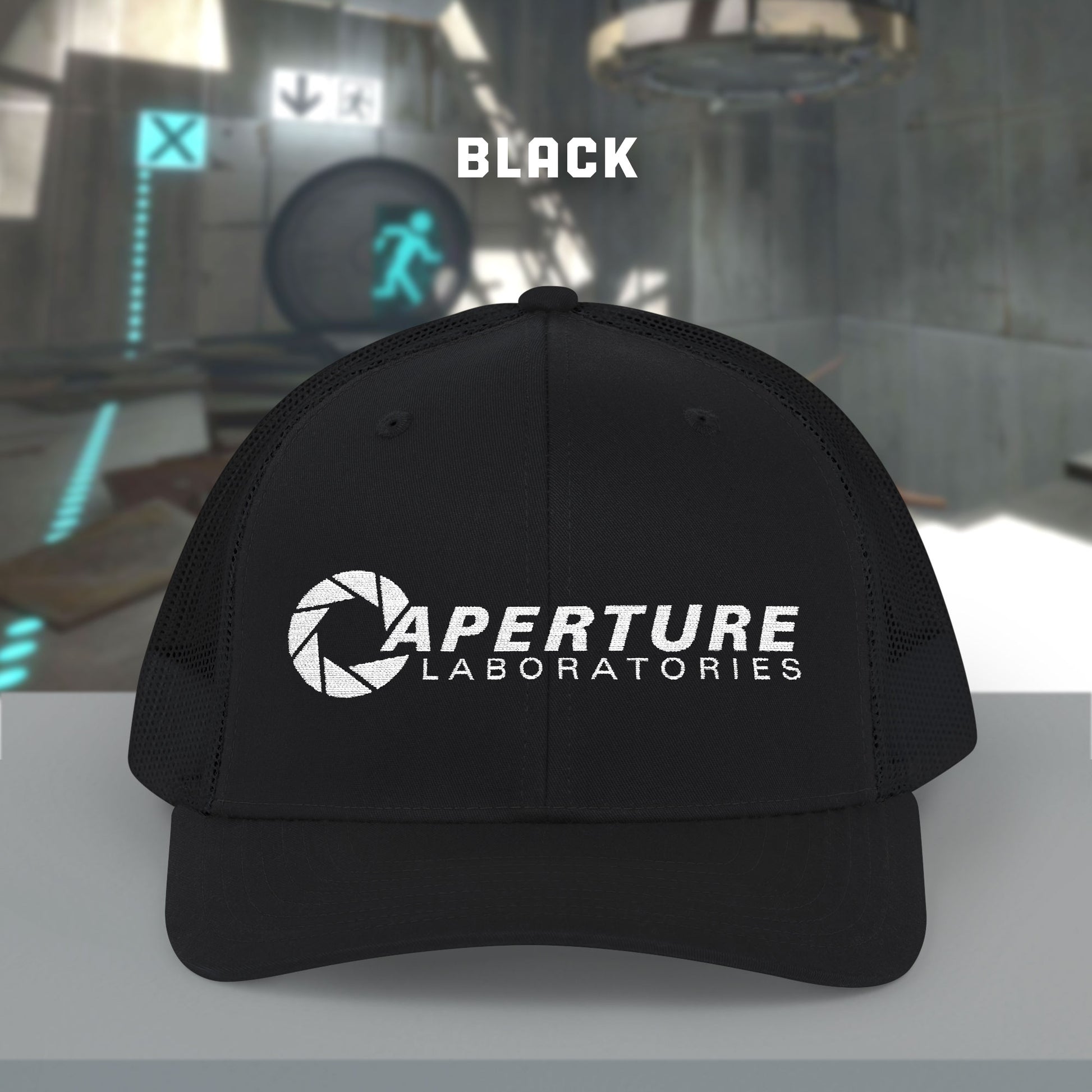 Front view of a black colored Richardson 112 Snapback Trucker Cap featuring the embroidered logo of the fictional company Aperture Laboratories from the video game Portal and Portal 2, sold by ScriptedBrand. 