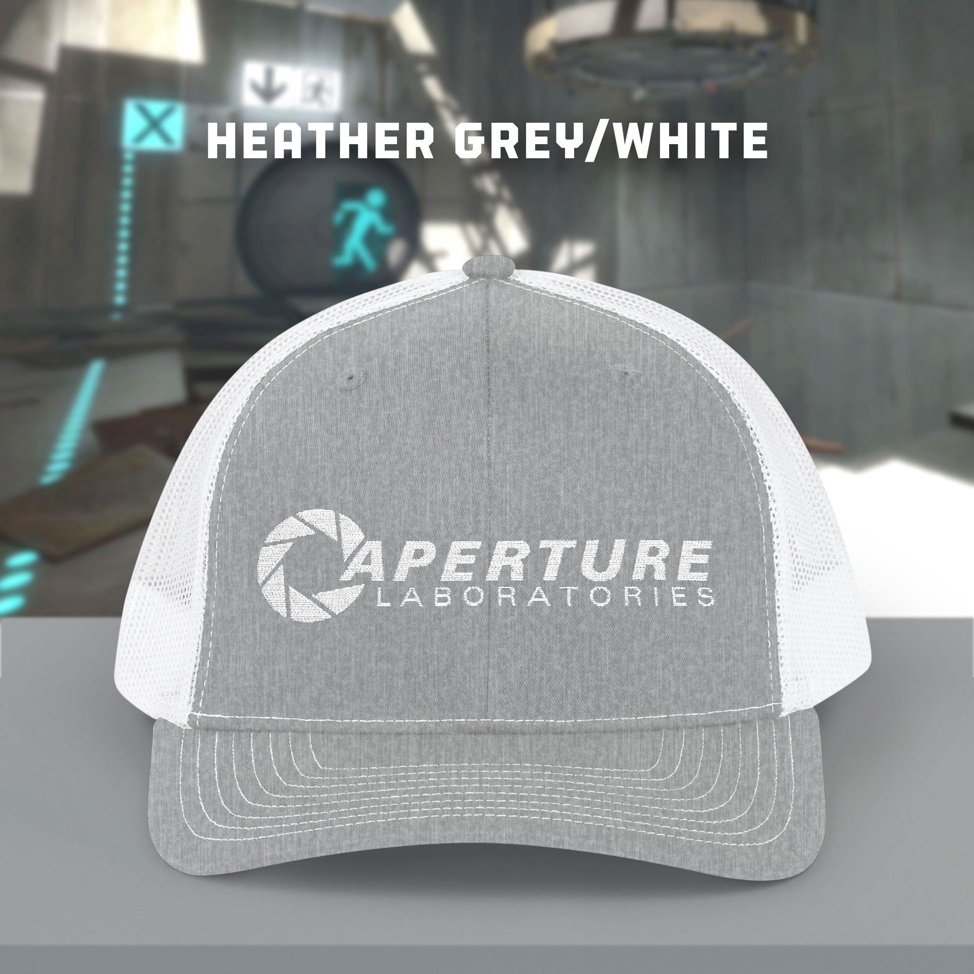 Front view of a heather grey/white colored Richardson 112 Snapback Trucker Cap featuring the embroidered logo of the fictional company Aperture Laboratories from the video game Portal and Portal 2, sold by ScriptedBrand. 