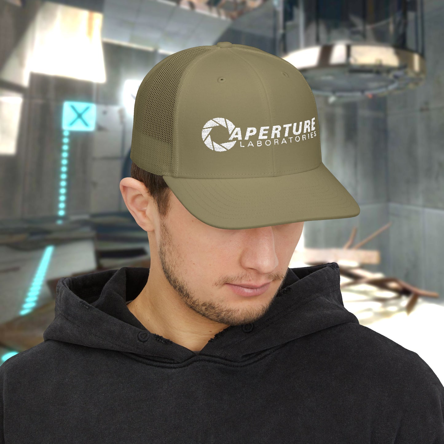 Male model wearing a loden gold colored Richardson 112 Snapback Trucker Cap featuring the embroidered logo of the fictional company Aperture Laboratories from the video game Portal and Portal 2, sold by ScriptedBrand. 