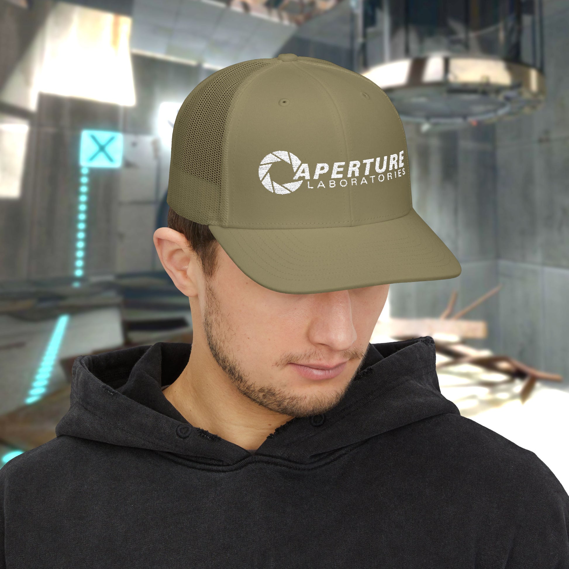 Male model wearing a loden gold colored Richardson 112 Snapback Trucker Cap featuring the embroidered logo of the fictional company Aperture Laboratories from the video game Portal and Portal 2, sold by ScriptedBrand. 