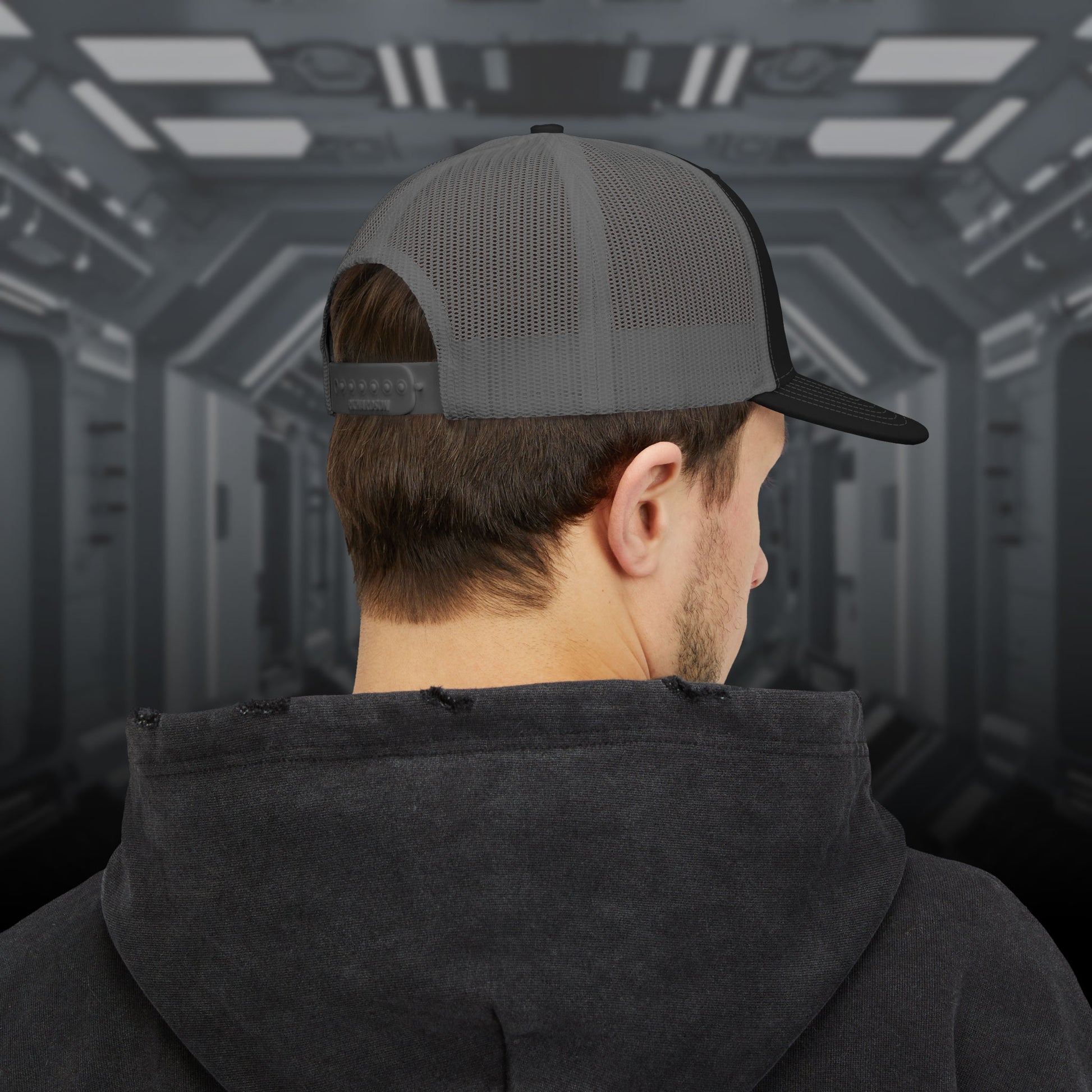 Back view of man wearing a Richardson 112 trucker cap with embroidered Weyland-Yutani logo inspired by Alien movies.
