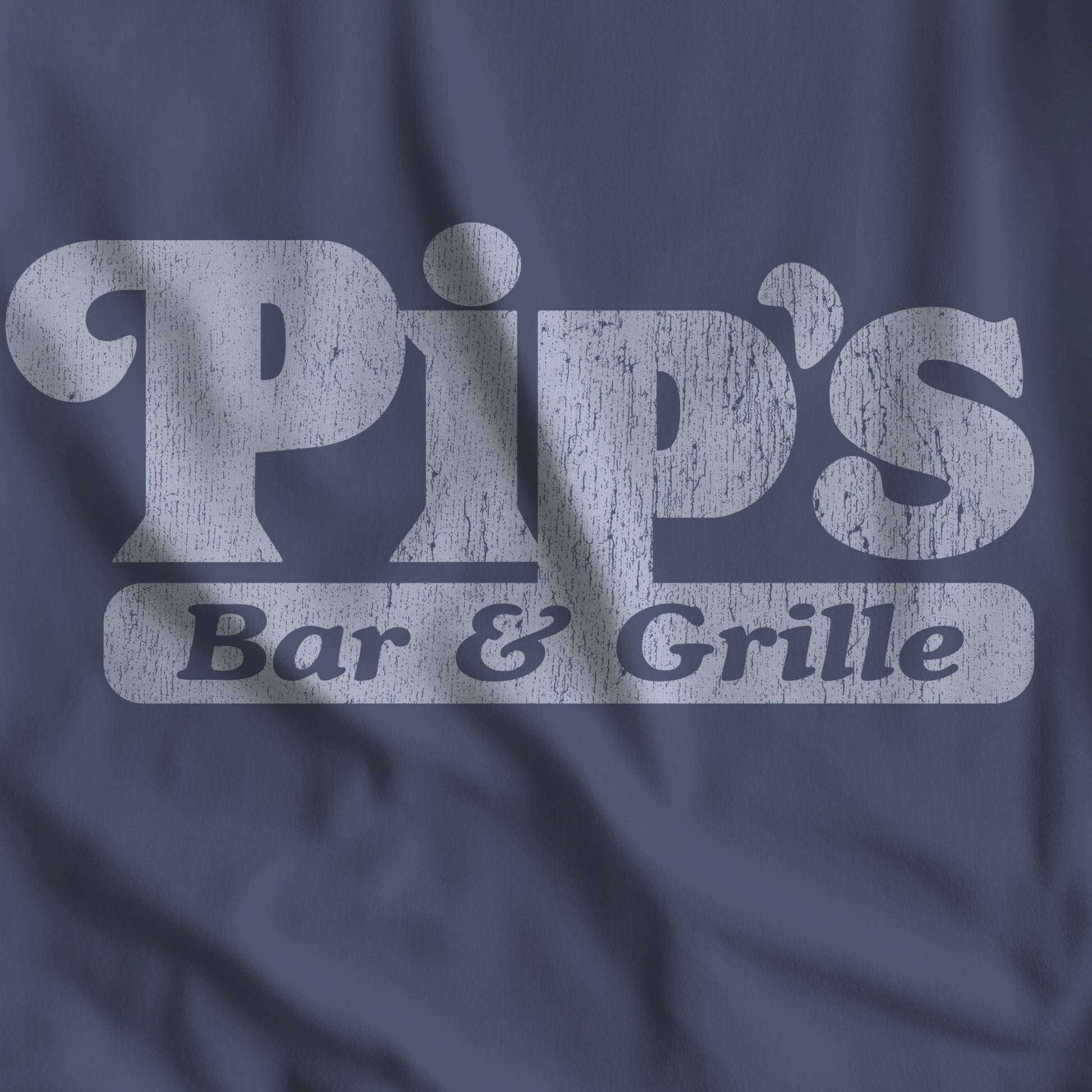 Closeup of midnight blue vintage-style Pip’s Bar and Grill t-shirt from TV show Severance on Comfort Colors 1717 tee.
