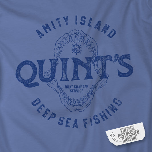 Closeup view of Mystic Blue Comfort Colors t-shirt with vintage Quint’s Deep Sea Fishing logo from Jaws, with shark graphic, distressed style.