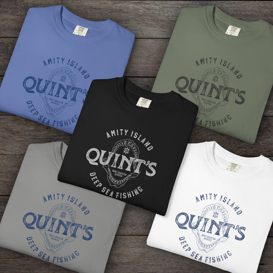 5 Folded Comfort Colors t-shirts with vintage Quint’s Deep Sea Fishing logo from Jaws, with shark graphic, distressed style.