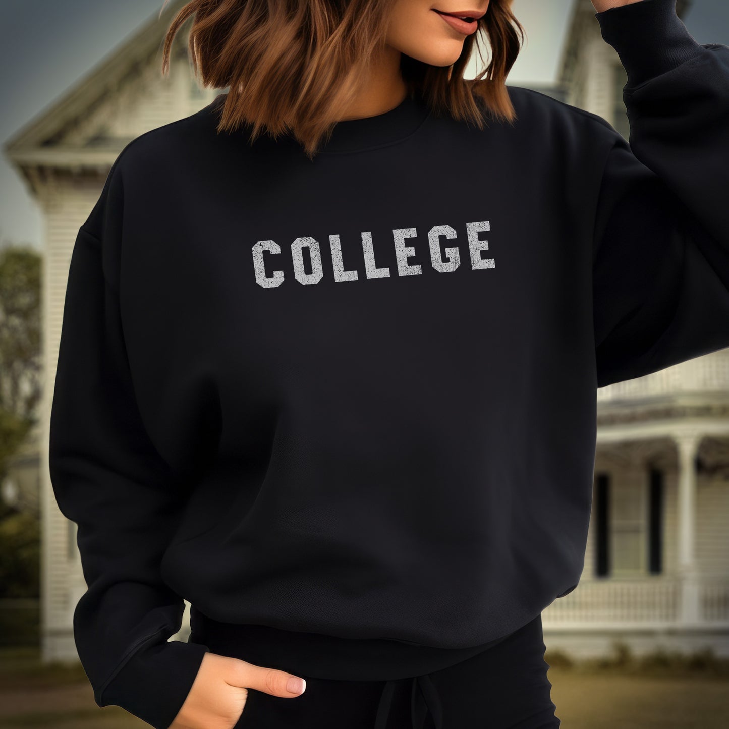 Female model wearing a black colored soft unisex Gildan 18000 sweatshirt with the word COLLEGE that John Belushi wore in the movie Animal House, in a vintage distressed ink-stamped worn-in style, sold by ScriptedBrand.