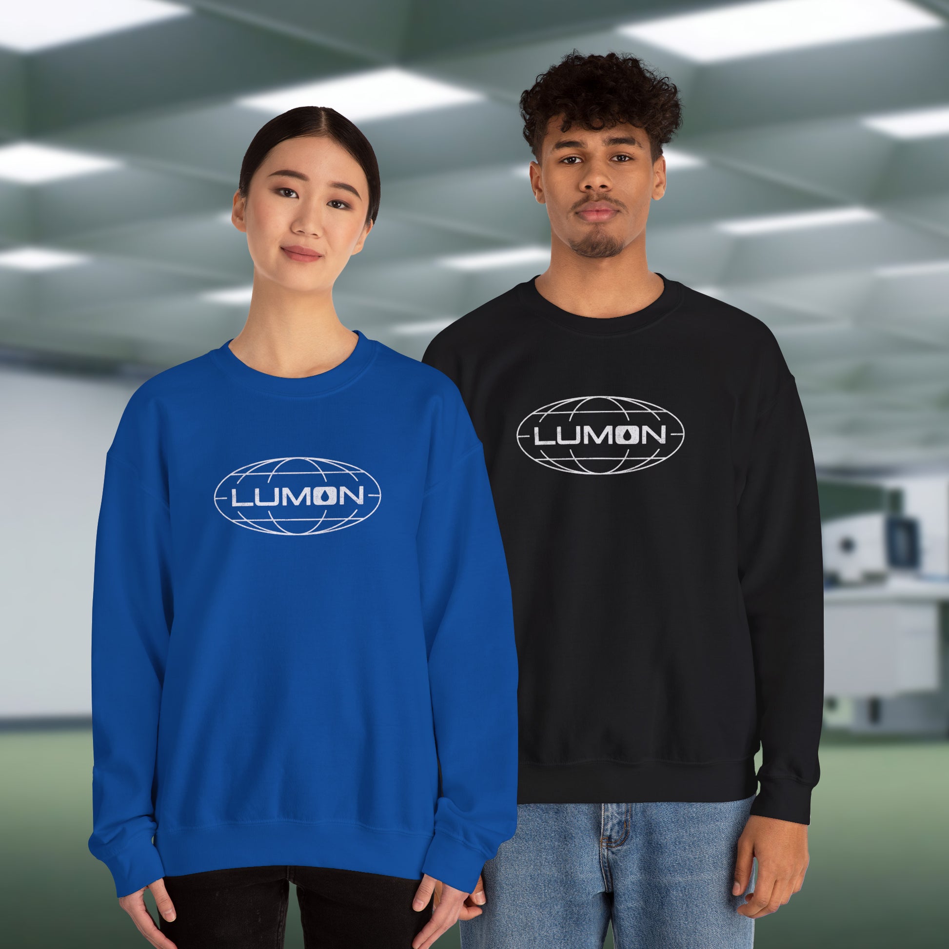 2 models wearing royal blue and black Gildan 18000 crew neck sweatshirts featuring the Lumon Industries logo from the Apple TV show Severance in a vintage distressed style.