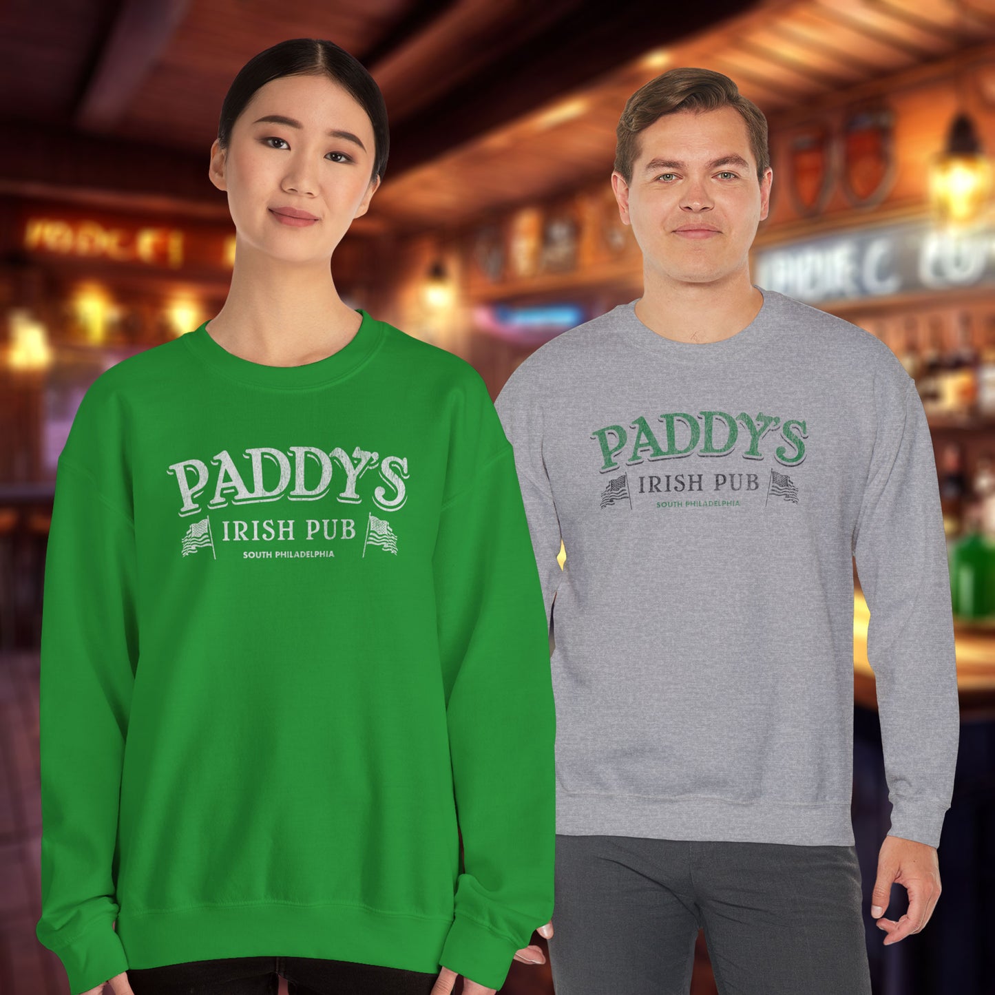 Two people wearing Crewneck Sweatshirts with the Paddy's Pub logo graphic from the TV Show Its Always Sunny in Philadelphia in a vintage style.