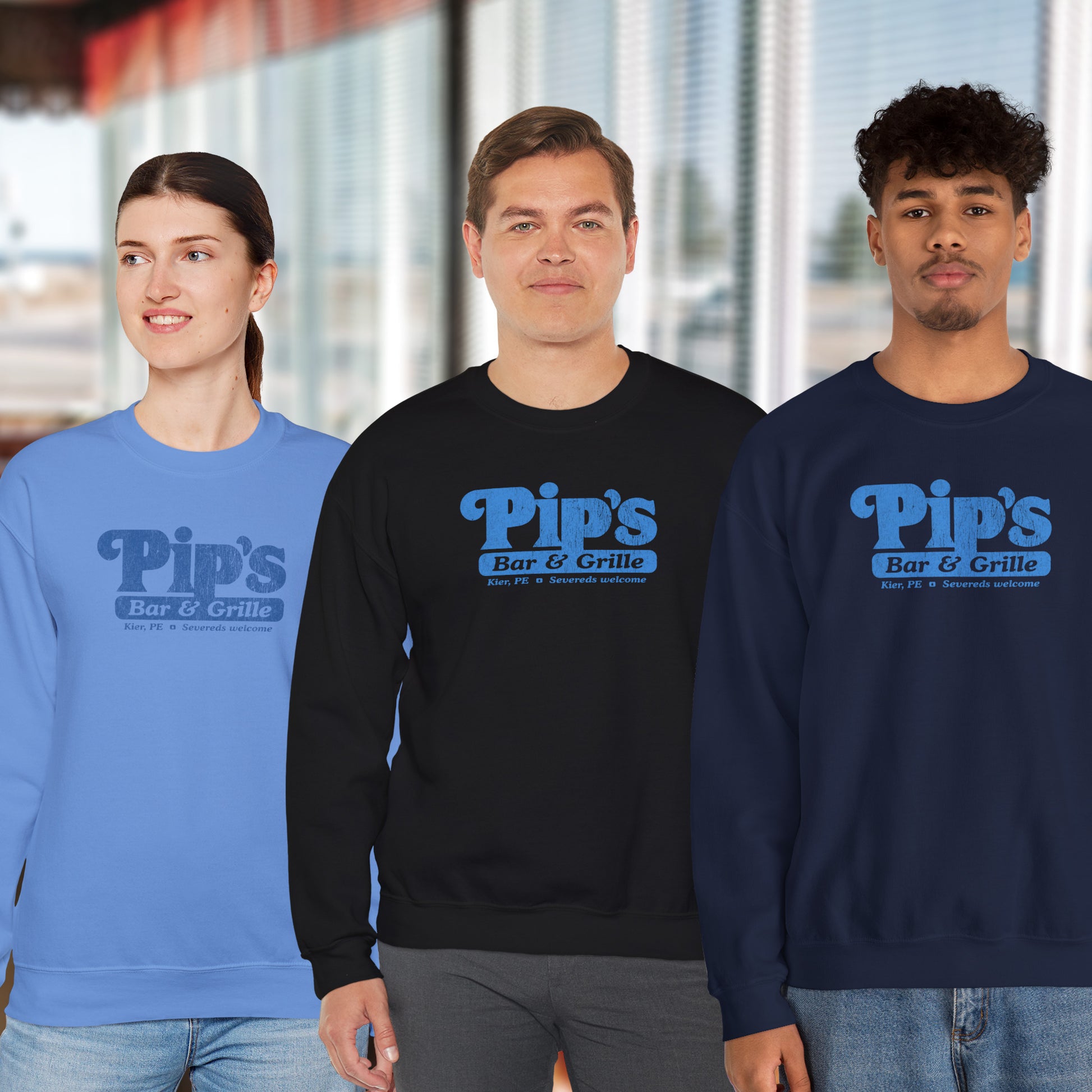 3 models wearing Soft Gildan 18000 sweatshirts featuring the Pips Bar and Grill logo Severeds Welcome from the TV show Severance in a vintage distressed ink-stamped worn-in style.