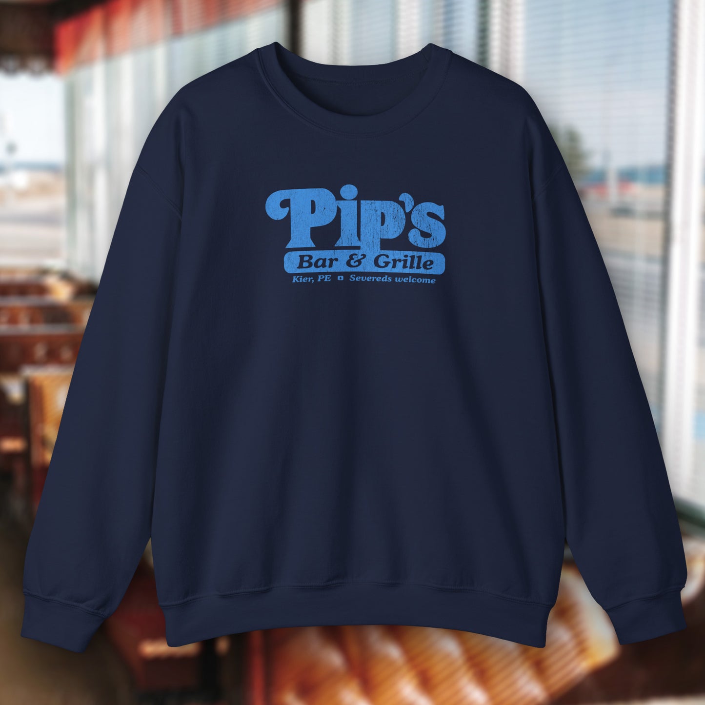 Navy blue soft Gildan 18000 sweatshirt featuring the Pips Bar and Grill logo Severeds Welcome from the TV show Severance in a vintage distressed ink-stamped worn-in style.