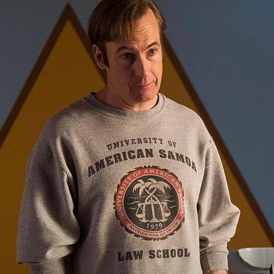 Jimmy McGill in the TV show Better Call Saul wearing a gray sweatshirt with 'University of American Samoa Law School' text and logo.