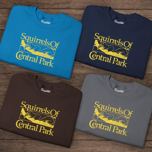Four folded Squirrels Of Central Park vintage distressed crewneck sweatshirts inspired by Bad Sisters, shown on wooden background.