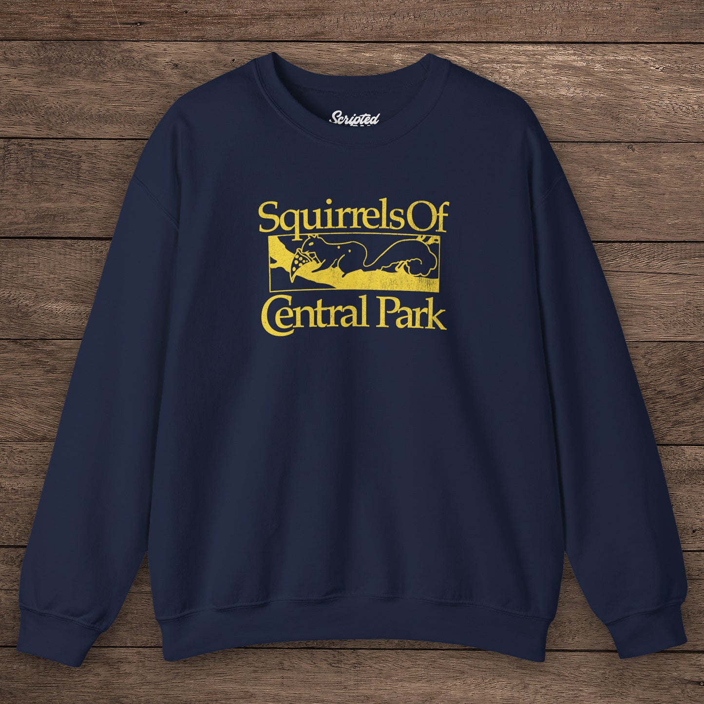 Navy blue Squirrels Of Central Park vintage distressed crewneck sweatshirt inspired by Bad Sisters, shown on wooden background.