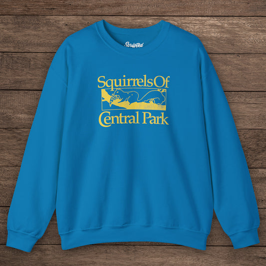 Sapphire blue Squirrels Of Central Park vintage distressed crewneck sweatshirt inspired by Bad Sisters, shown on wooden background.