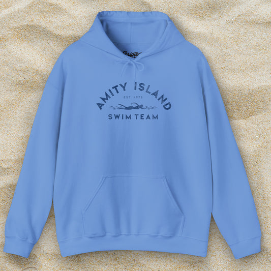 Front view of a Carolina Blue colored Soft Unisex Hoodie Heavy Blend Hooded Sweatshirt featuring an Amity Island Swim Team logo graphic, designed by ScriptedBrand, and  inspired by the movie Jaws in a vintage distressed style.