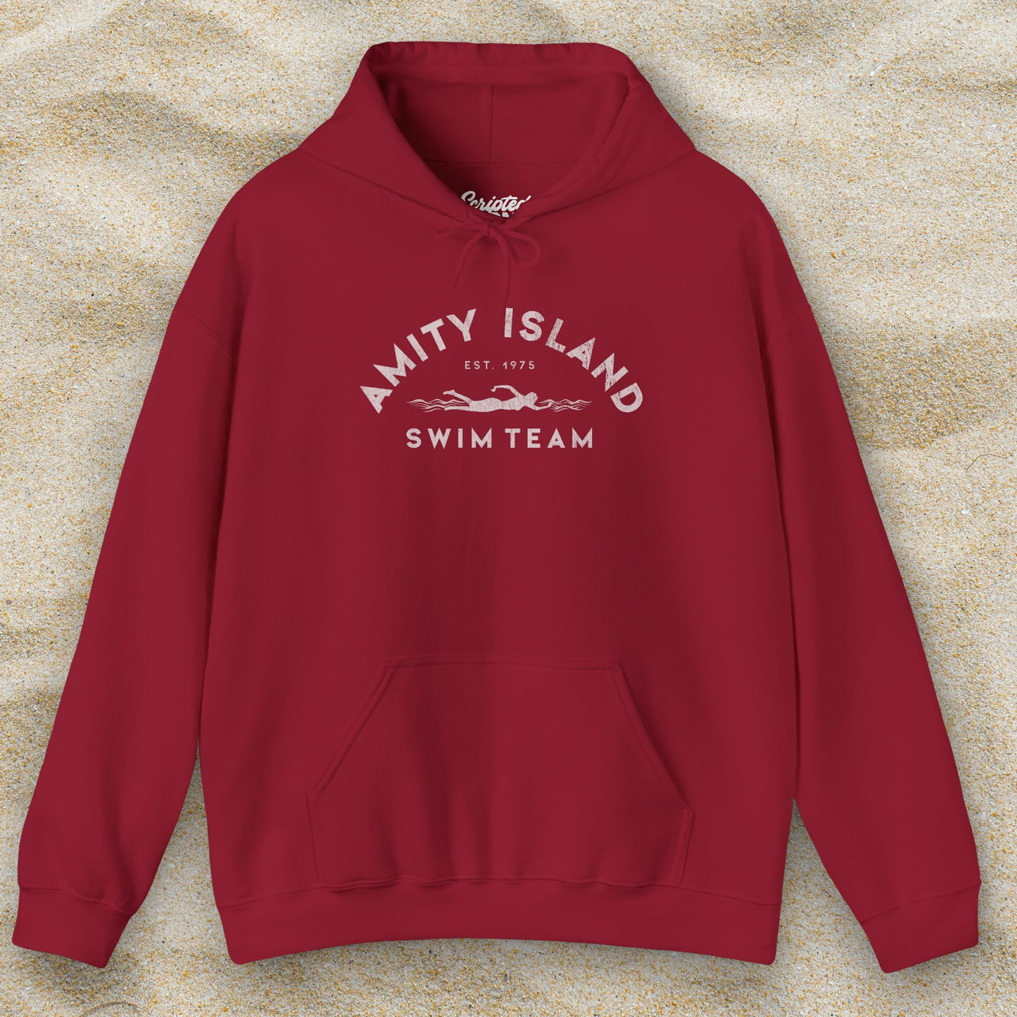 Front view of a cardinal red lifeguard colored Soft Unisex Hoodie Heavy Blend Hooded Sweatshirt featuring an Amity Island Swim Team logo graphic, designed by ScriptedBrand, and  inspired by the movie Jaws in a vintage distressed style.