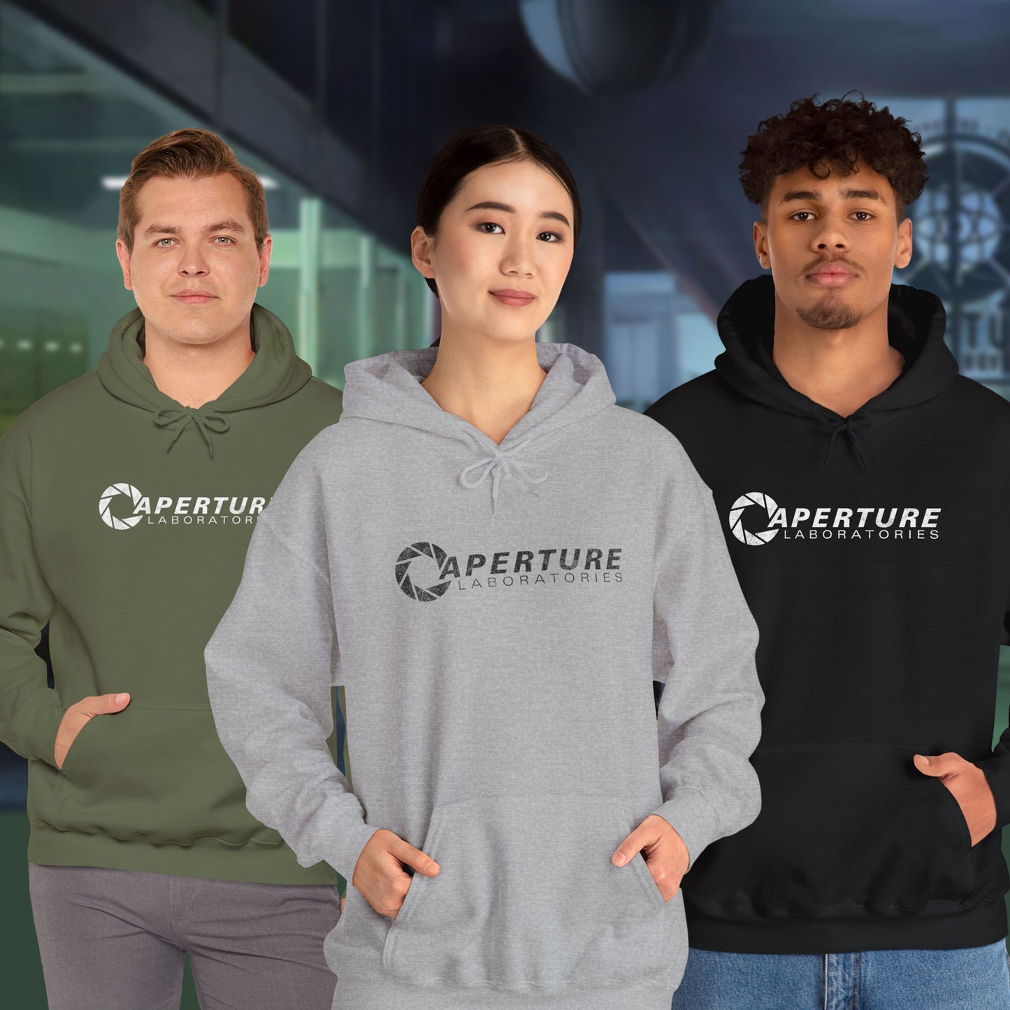3 models wearing Unisex Hoodie Heavy Blend Hooded Sweatshirts featuring the Aperture Laboratories logo from the video game Portal and Portal 2 in a vintage distressed style, sold by ScriptedBrand.