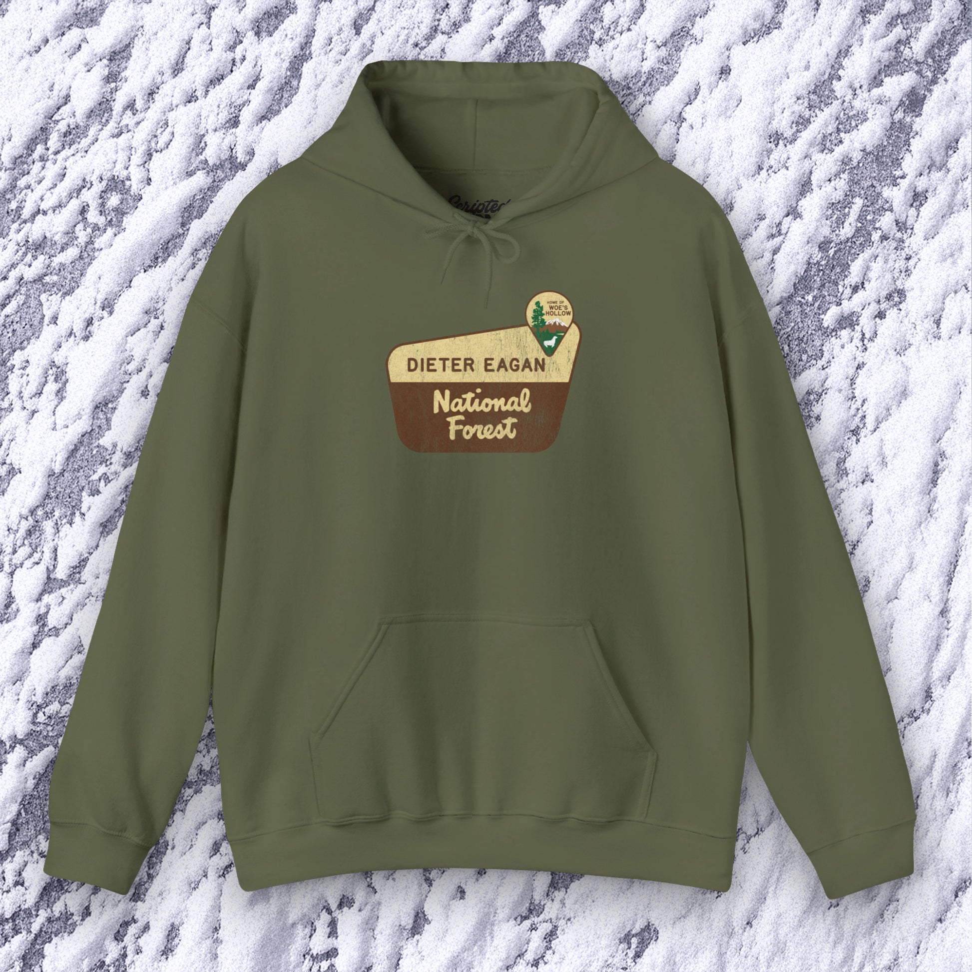 Mockup of a Military green colored Soft Unisex Hoodie Heavy Blend Hooded Sweatshirt featuring the logo graphic of the Dieter Eagan National Forest inspired by the TV show Severance in a vintage distressed ink-stamped worn-in style.
