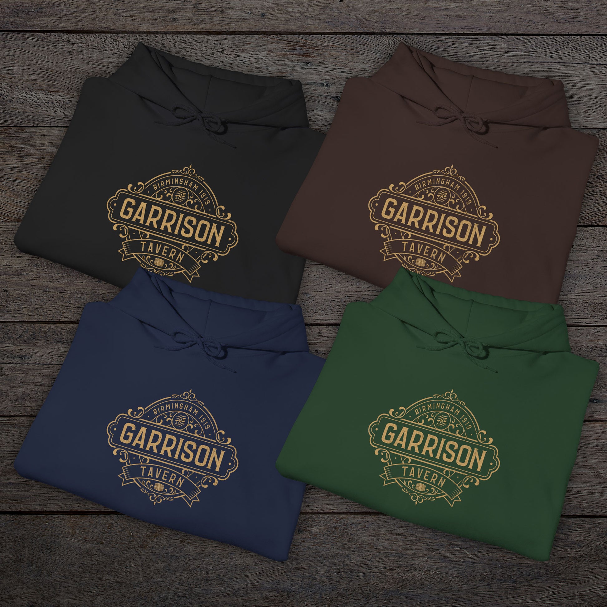 Group of 4 folded Soft Unisex Hoodie Heavy Blend Hooded Sweatshirts featuring the Garrison Tavern Bar Logo Graphic inspired by the TV show and movie Peaky Blinders in a vintage distressed style sold by ScriptedBrand.