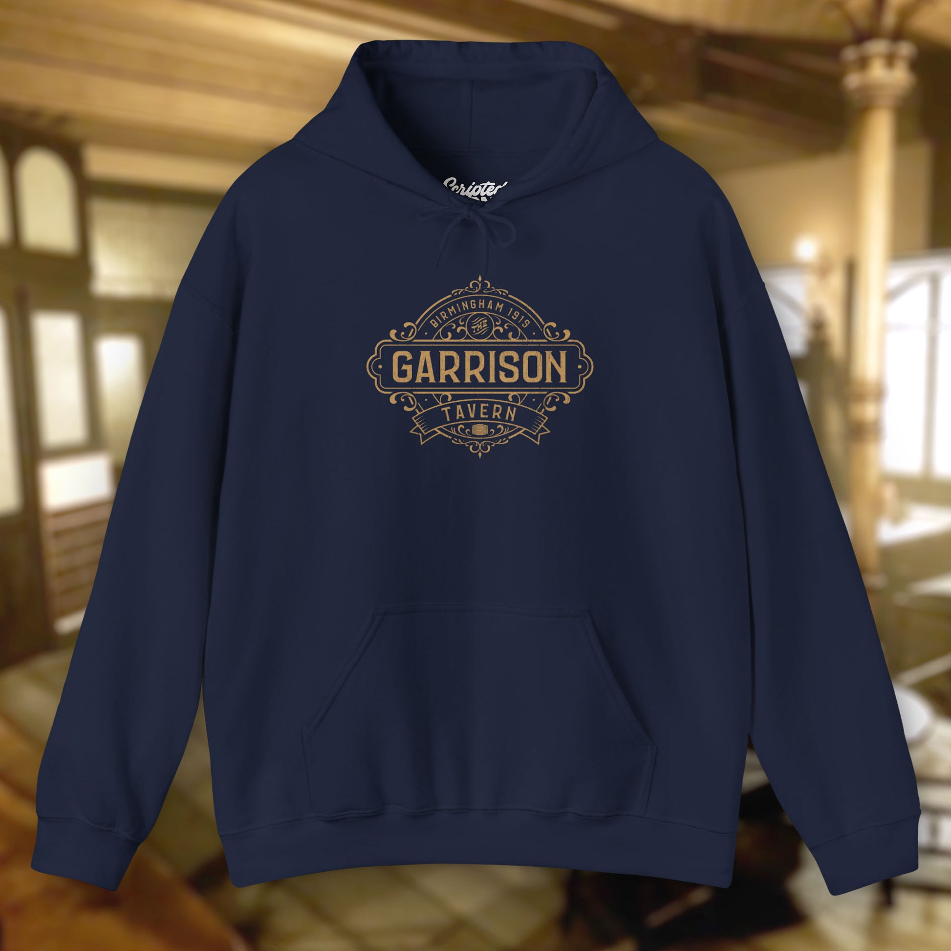 Front view of a navy blue Soft Unisex Hoodie Heavy Blend Hooded Sweatshirts featuring the Garrison Tavern Bar Logo Graphic inspired by the TV show and movie Peaky Blinders in a vintage distressed style sold by ScriptedBrand.
