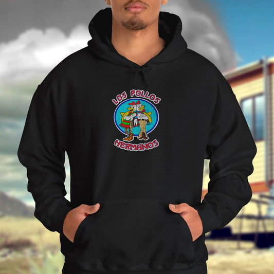Male model wearing black Soft Unisex Hoodie Heavy Blend Hooded Sweatshirt featuring the Los Pollos Hermanos logo from the TV show Breaking Bad and Better Call Saul in a vintage distressed style. Logo is printed on both front and back of hoodie.