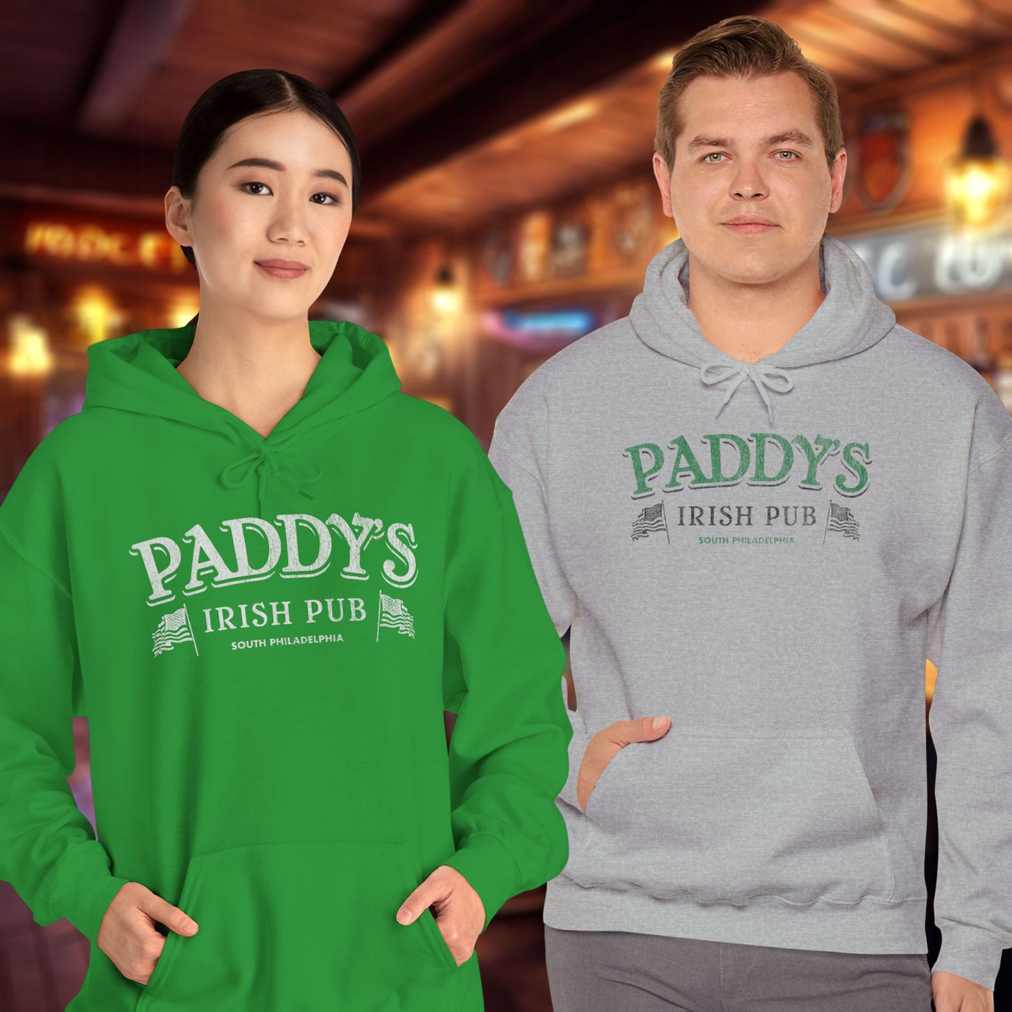 Two people wearing Hoodie Sweatshirts with the Paddy's Pub logo graphic from the TV Show Its Always Sunny in Philadelphia in a vintage style.