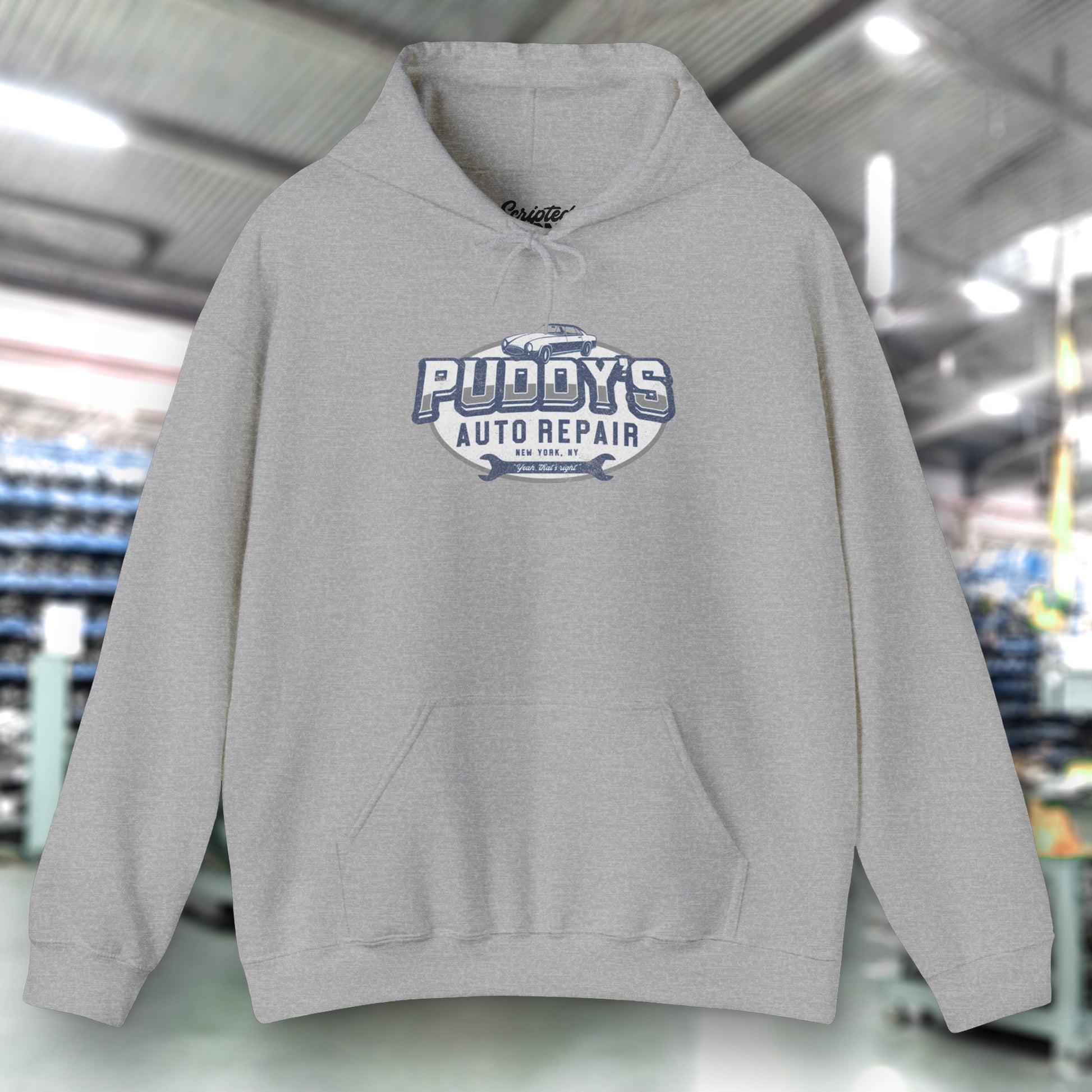 Front view of a sport heather gray soft Unisex Hoodie Heavy Blend Hooded Sweatshirt featuring a Puddy's Auto Repair graphic designed by ScriptedBrand inspired by the TV show Seinfeld in a vintage distressed style.