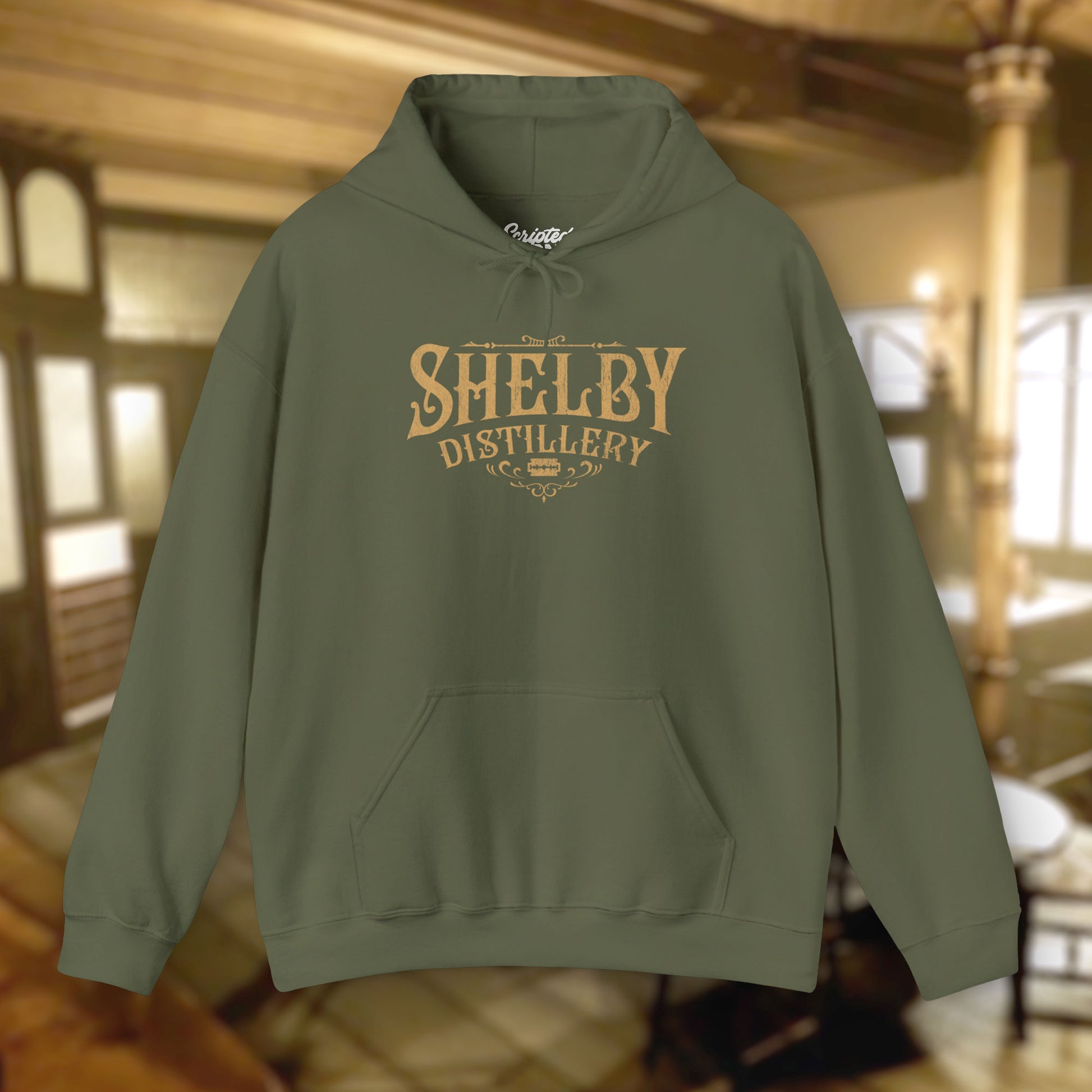 Military Green colored Unisex Hoodie Heavy Blend Hooded Sweatshirt featuring the Shelby Company Limited Distillery Logo Graphic inspired by the TV show and movie Peaky Blinders in a vintage distressed ink-stamped worn-in style.