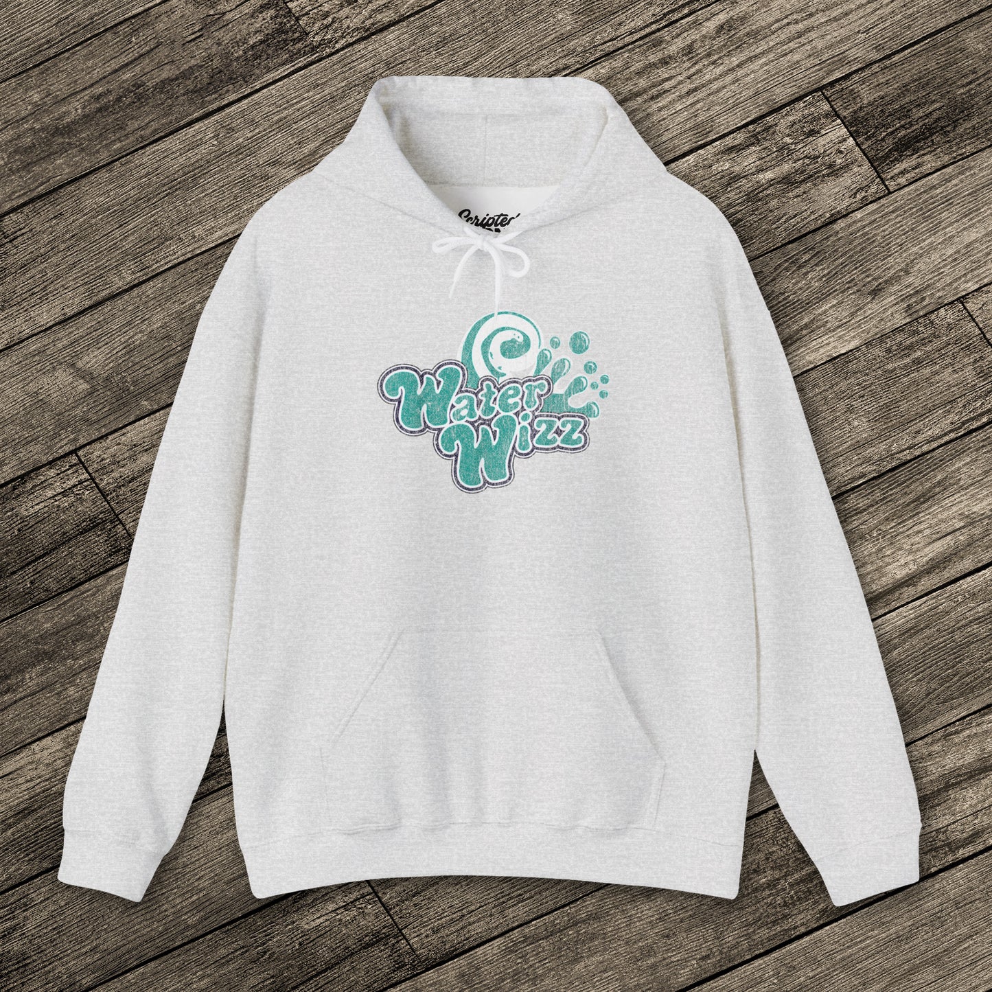 Ash gray Gildan 18500 pullover hoodie with vintage distressed Water Wizz logo from Grown Ups on the chest, shown on wood floor.