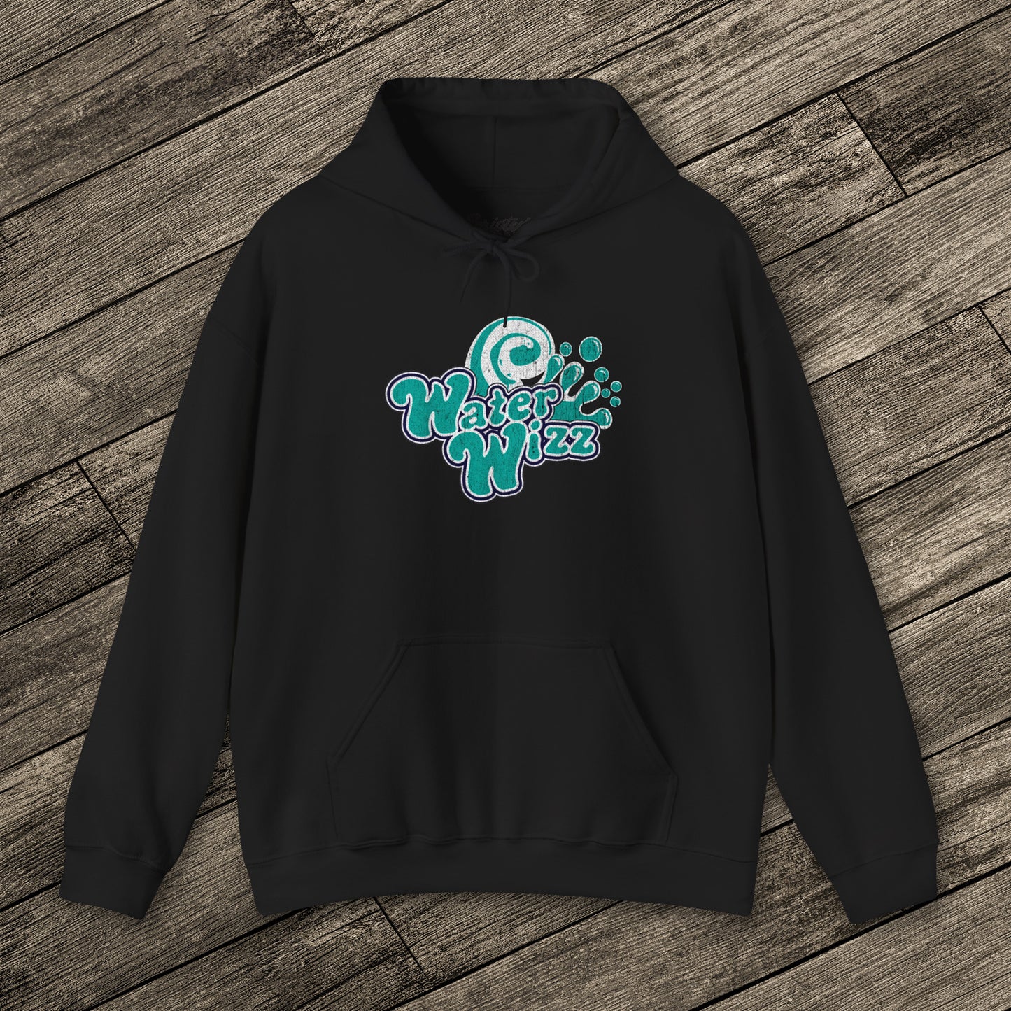 Black Gildan 18500 pullover hoodie with vintage distressed Water Wizz logo from Grown Ups on the chest, shown on wood floor.
