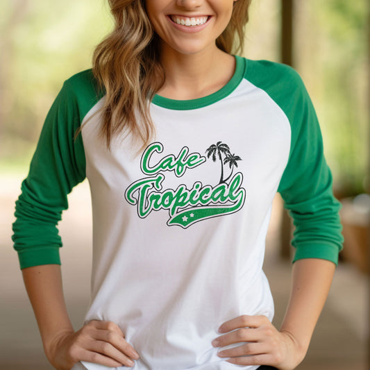 Female model wearing a white and Green colored soft raglan 3/4 sleeve Tultex 245 baseball shirt featuring the fictional Cafe Tropical logo that David wore in the TV Show Schitts Creek in a vintage distressed style, sold by ScriptedBrand.
