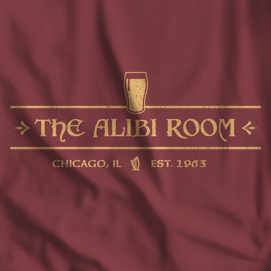 Closeup of maroon t-shirt featuring gold The Alibi Room logo graphic inspired by the TV show Shameless in a vintage distressed style.